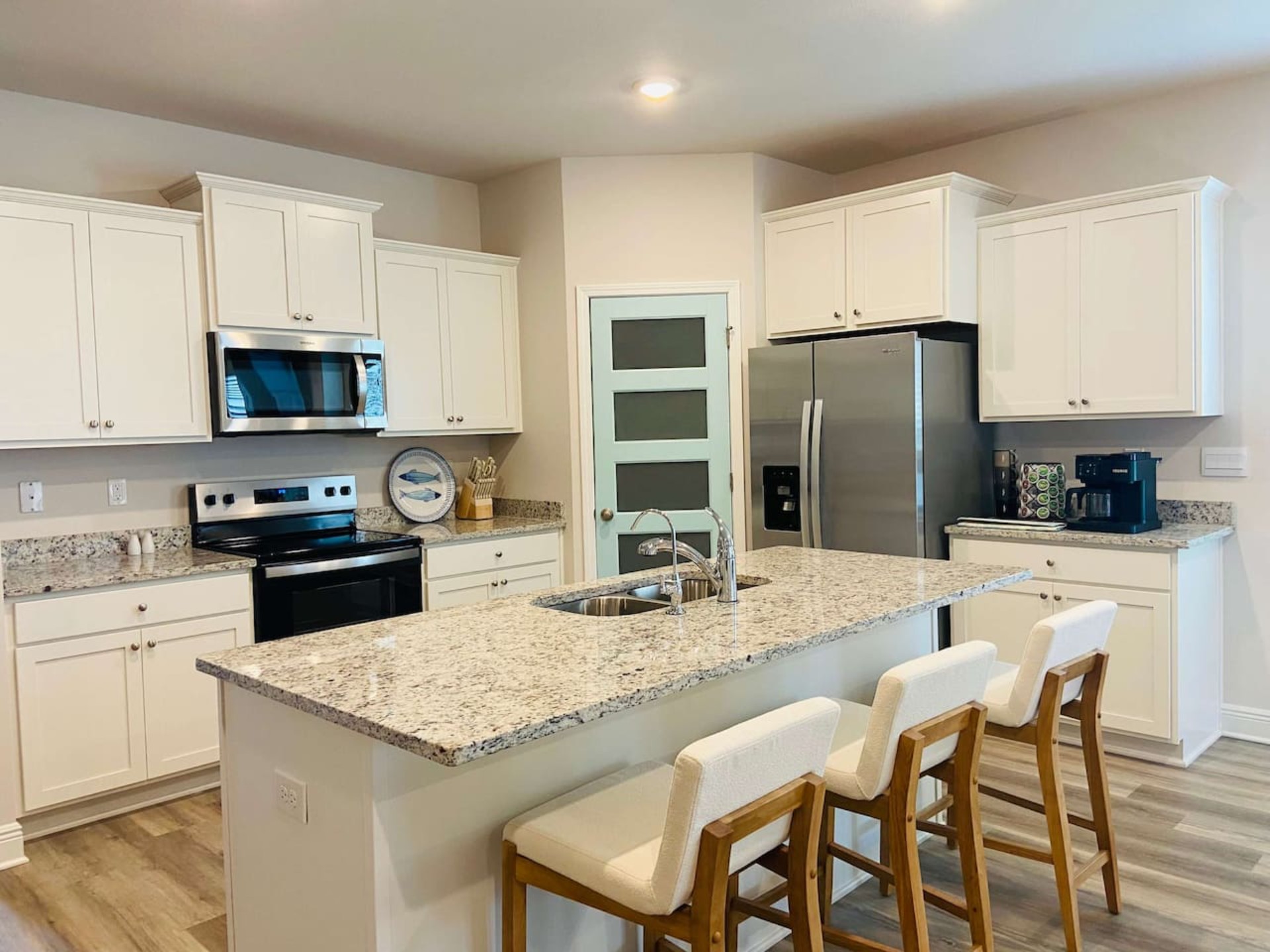 Modern, fully-equipped  kitchen with dual coffee maker and all essentials for cooking beachside feasts. 