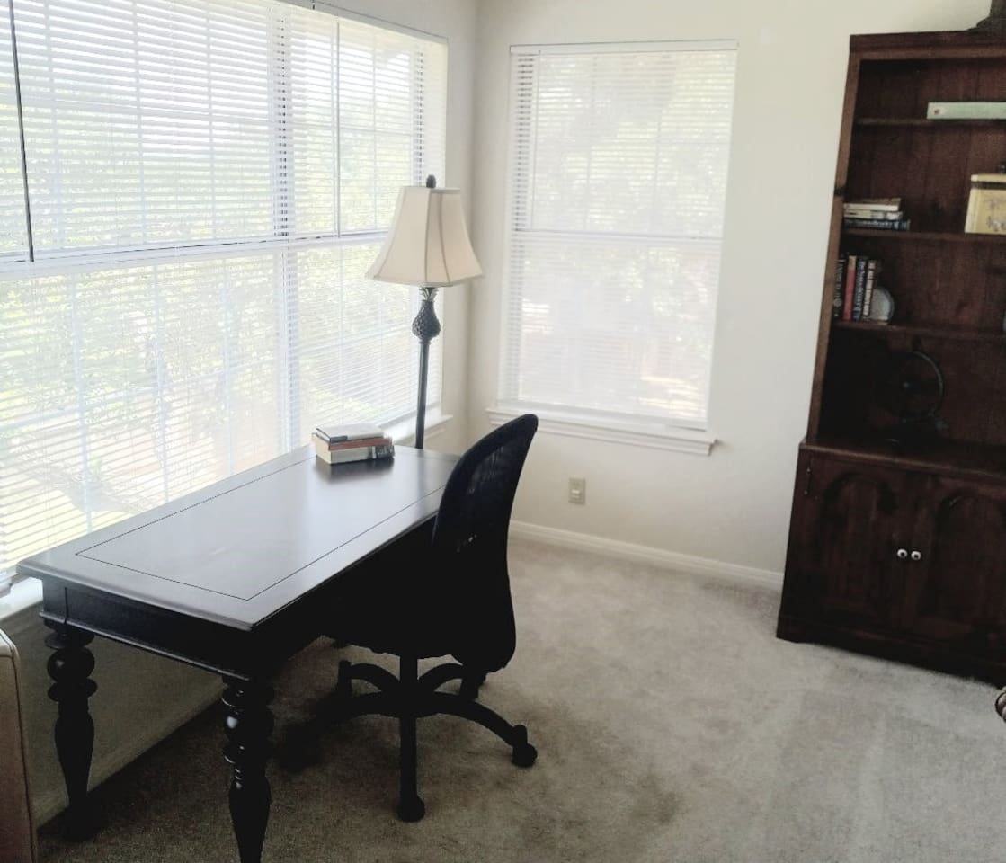 The office space adjoins the primary bedroom.  It is spacious, quiet and secluded and features views of the backyard.