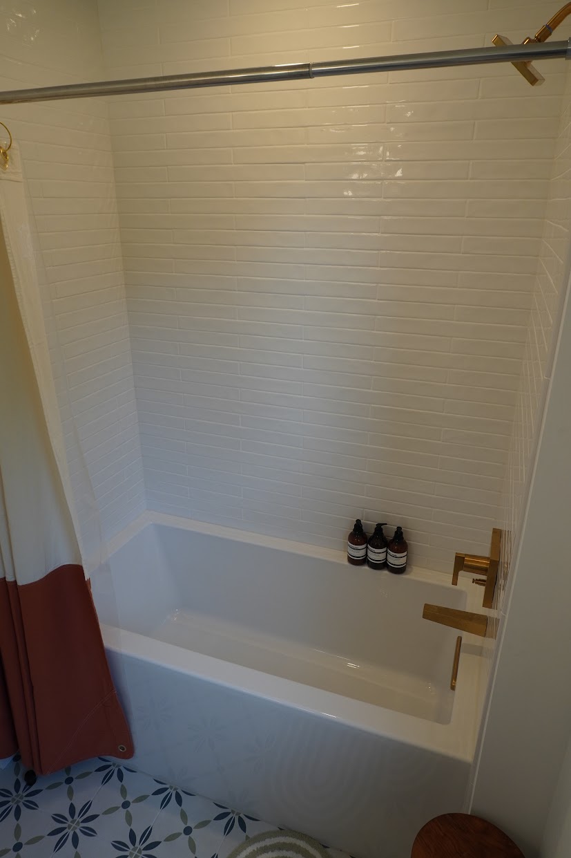 The second floor guest bathroom features a full size tub.