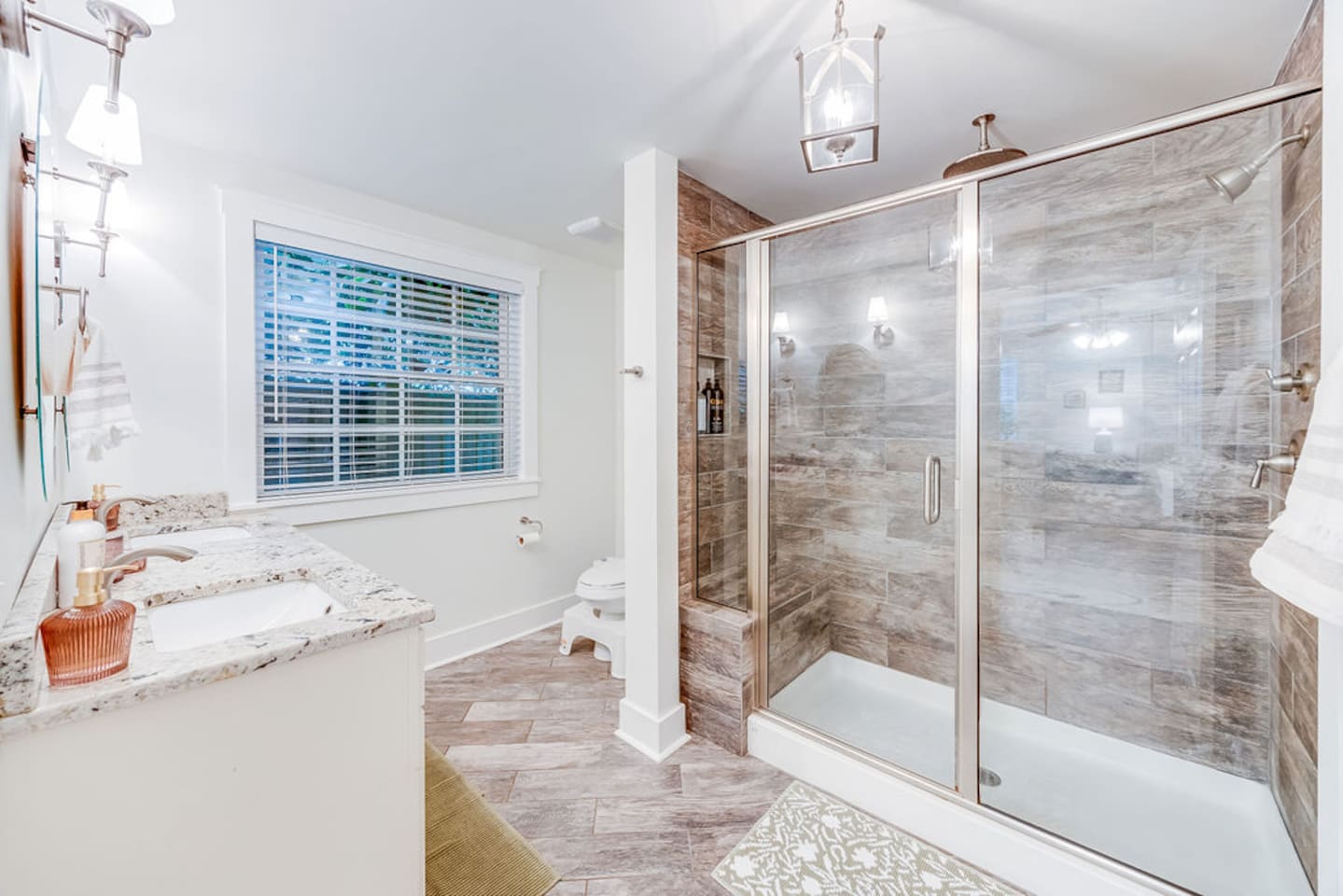 Spacious shower area paired with a sleek toilet, creating a functional and comfortable bathroom setup.