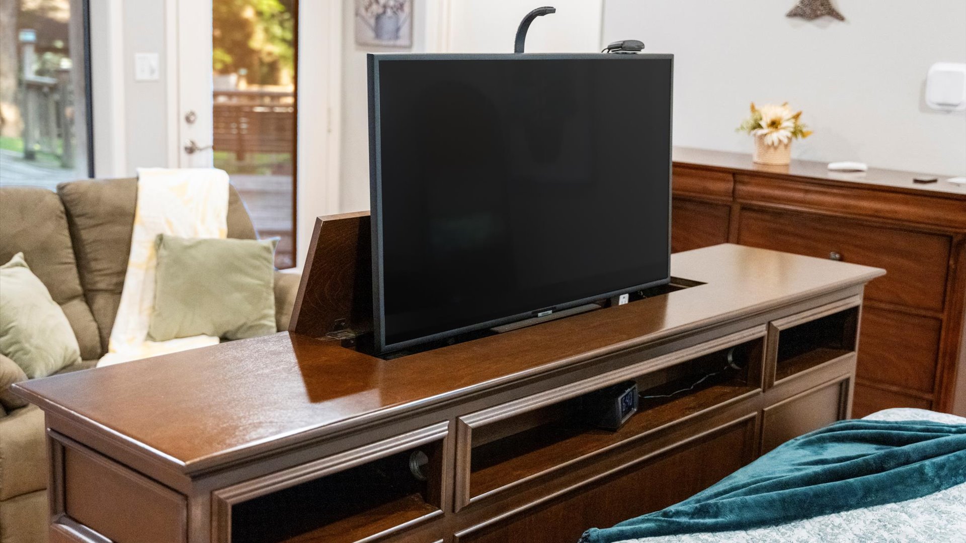 King 1 bedroom features a luxurious bed with a built-in footboard TV lift. Relax in comfort and enjoy your favorite shows with the touch of a button in this cozy and elegant retreat!