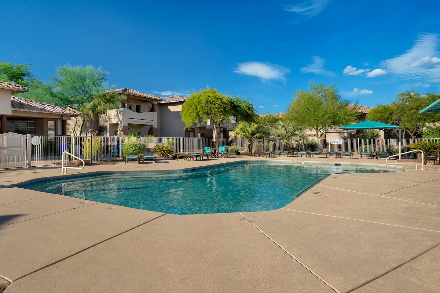 Resort-style community pool with lounge seating