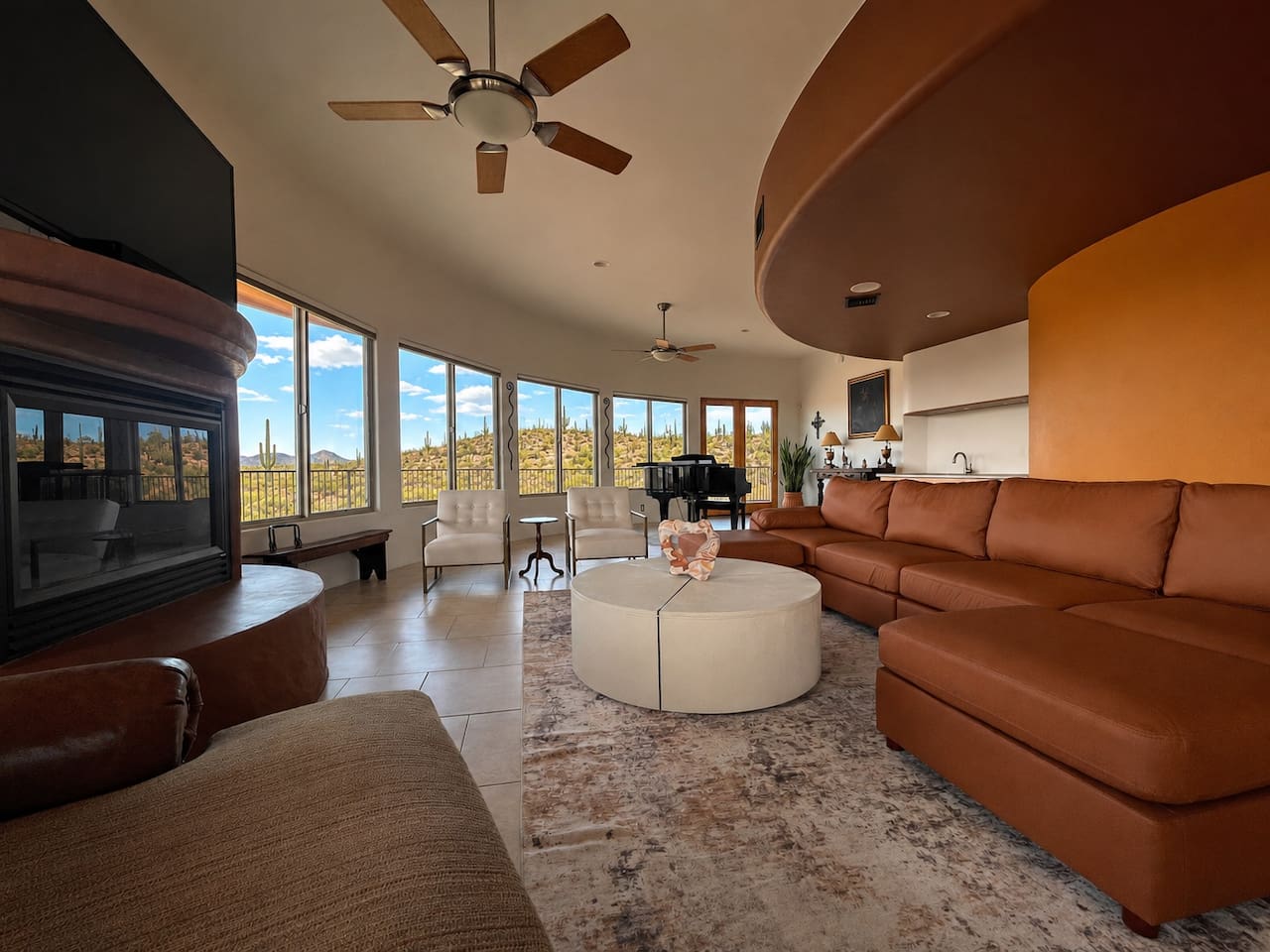 This open living room brings the sectional, fireplace, and piano together in one inviting shared space.