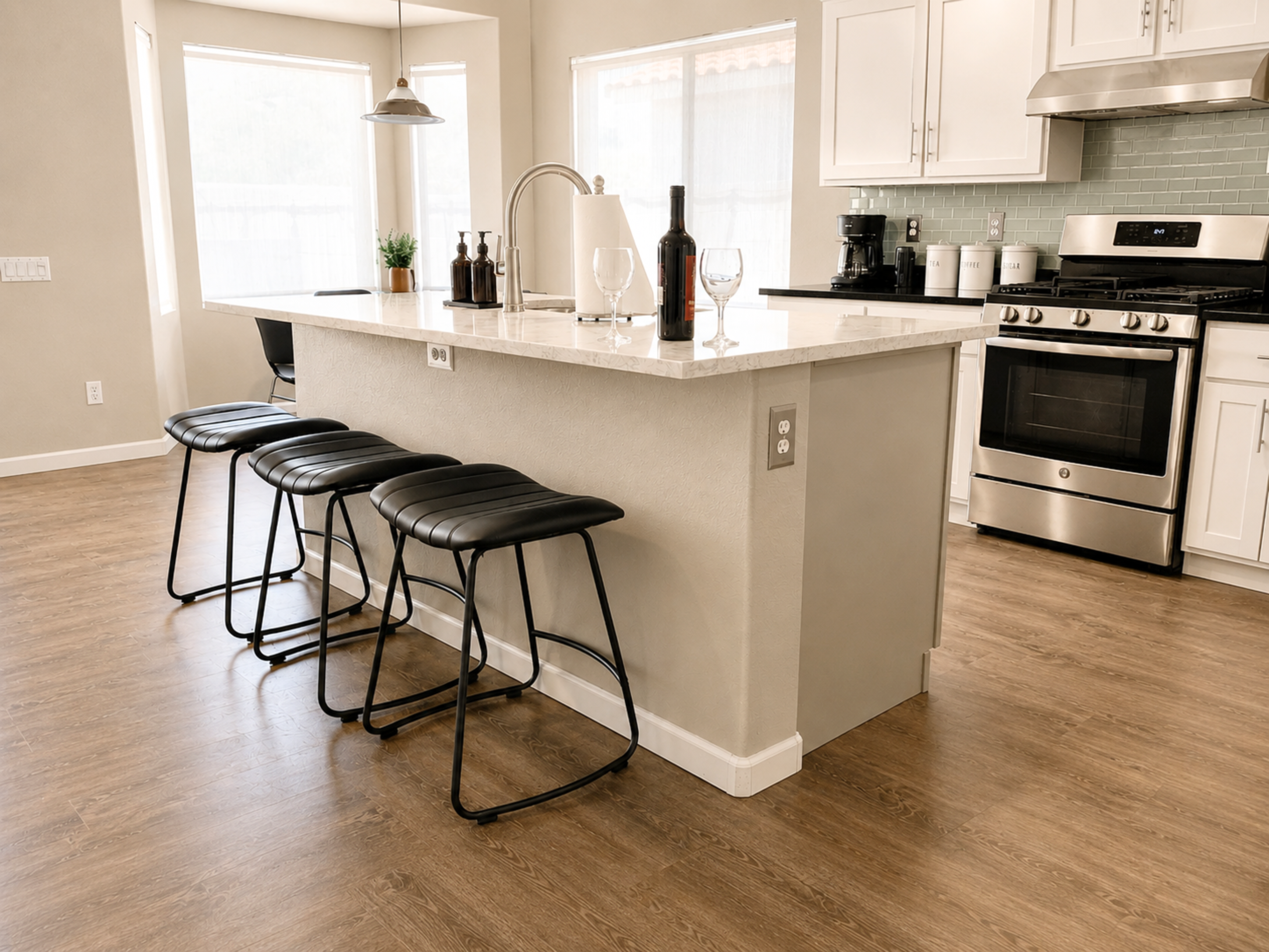 Sleek kitchen island with bar seating and stainless steel appliances — a perfect place for wine and conversation.