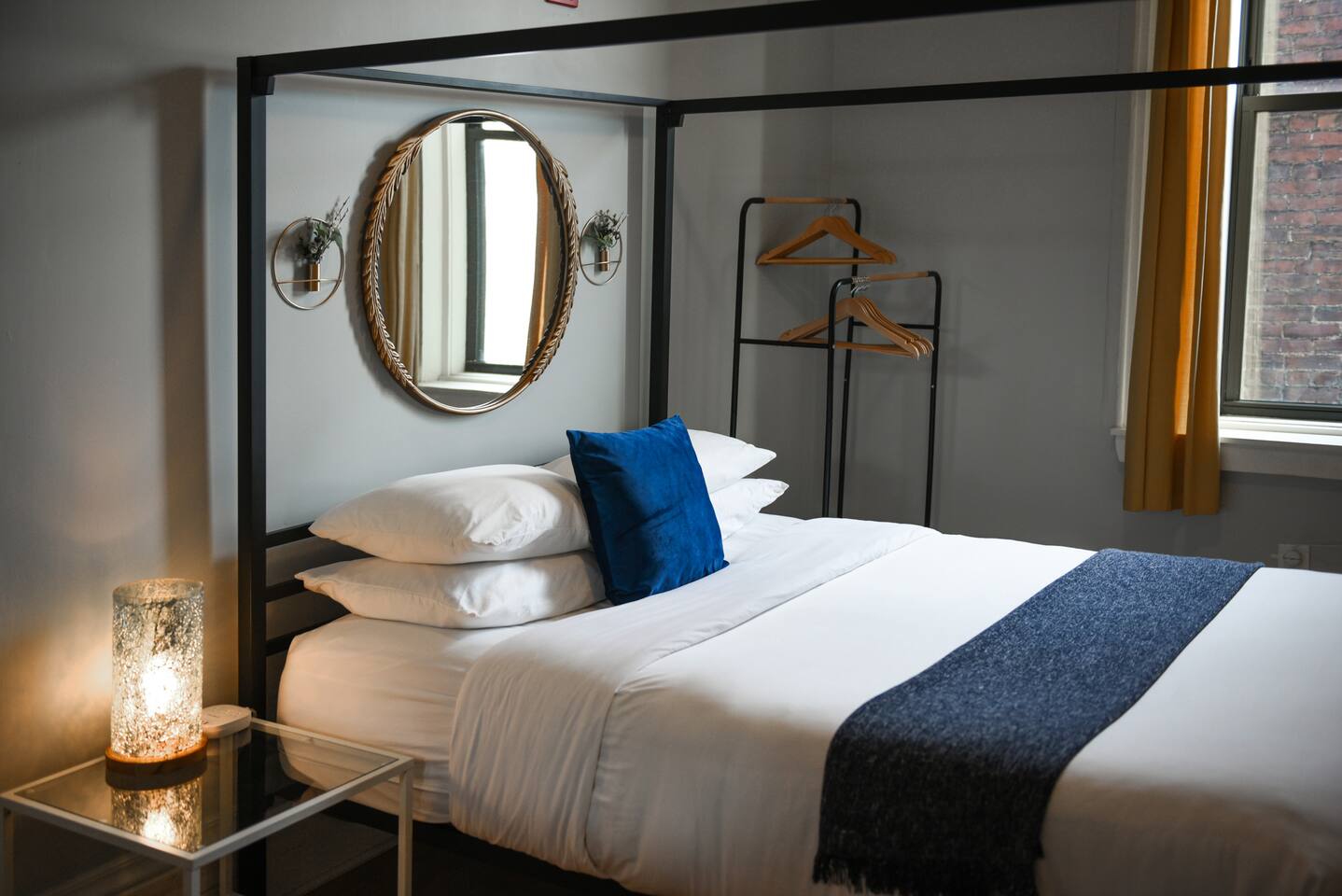 Cozy queen-sized bed with a unique frame and a TV for laid-back movie nights.