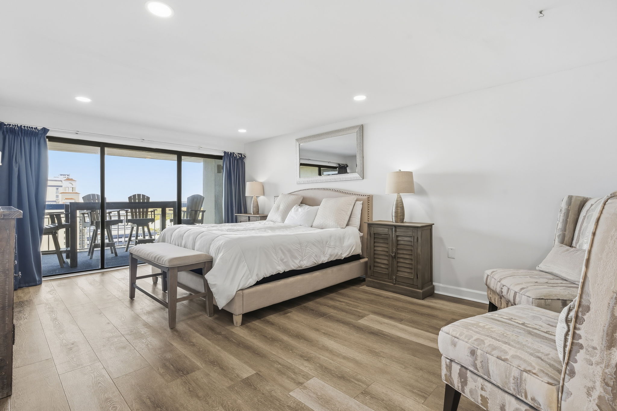 Primary bedroom with king bed and sliding doors to the balcony