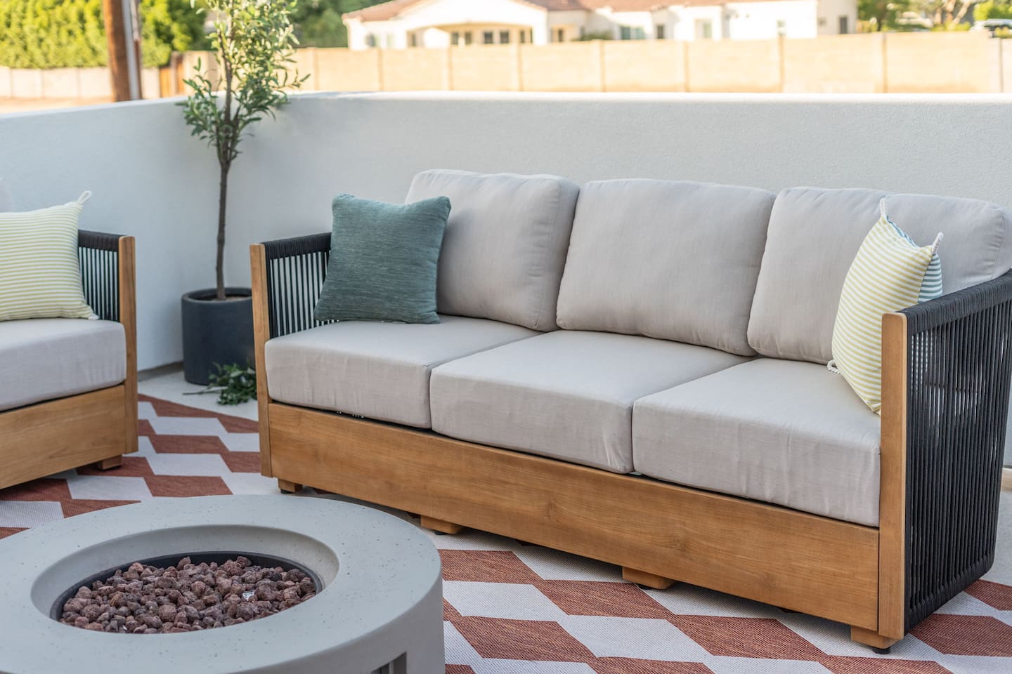 Modern fire pit surrounded by cushioned seating, ideal for evening conversations under the stars.