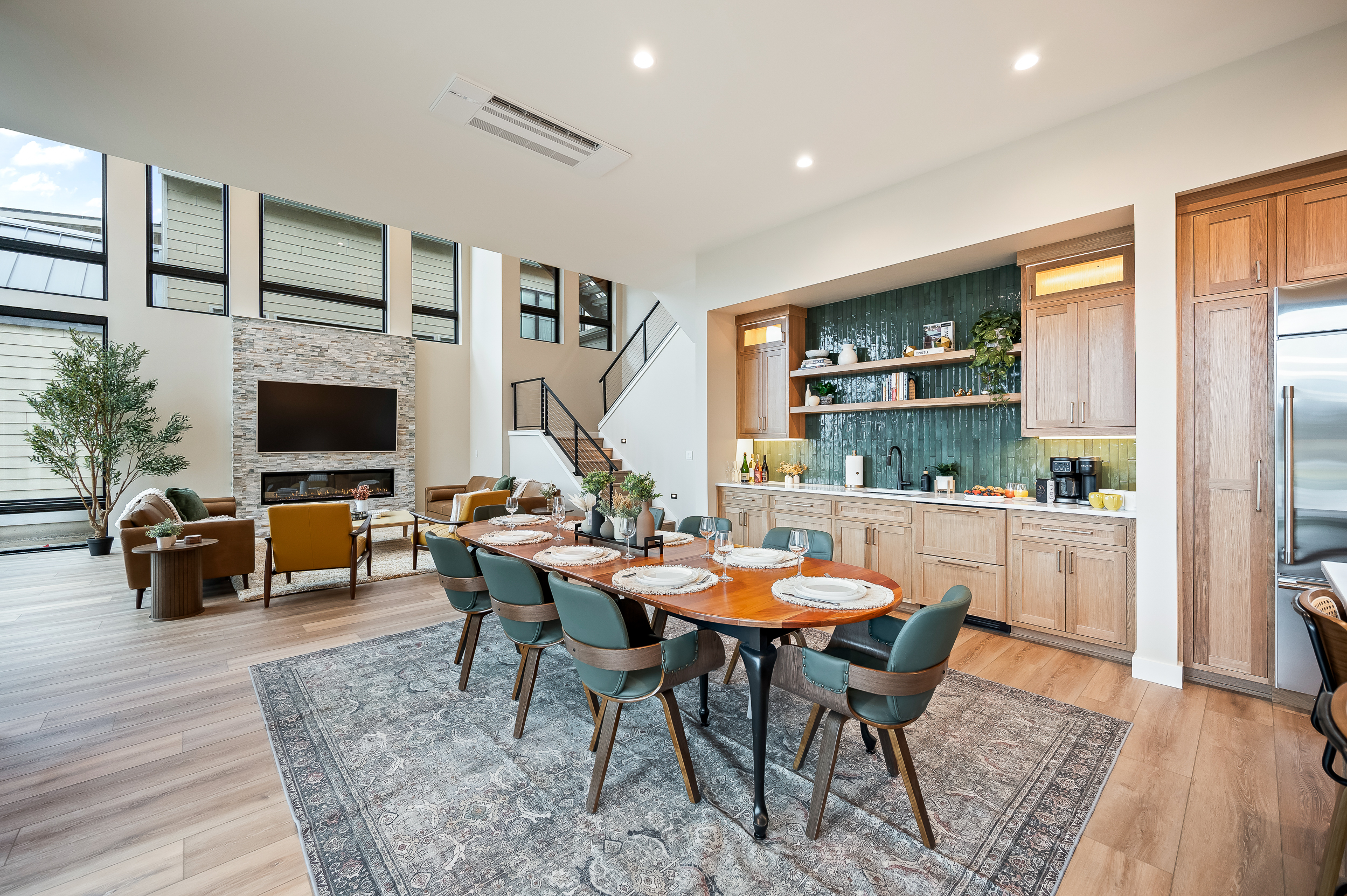 Main floor open concept living room, dining area, kitchen and wet bar. Enjoy lake view & glass wall sliding doors. Dining table has several extendable leaves and extra chairs to seat up to 12.