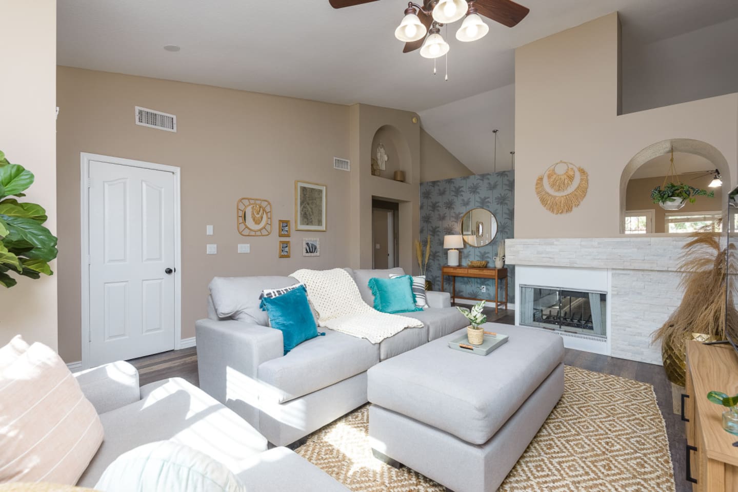 Living room with vaulted ceiling, large Smart TV, comfortable sectional seating, and room to relax or gather indoors.