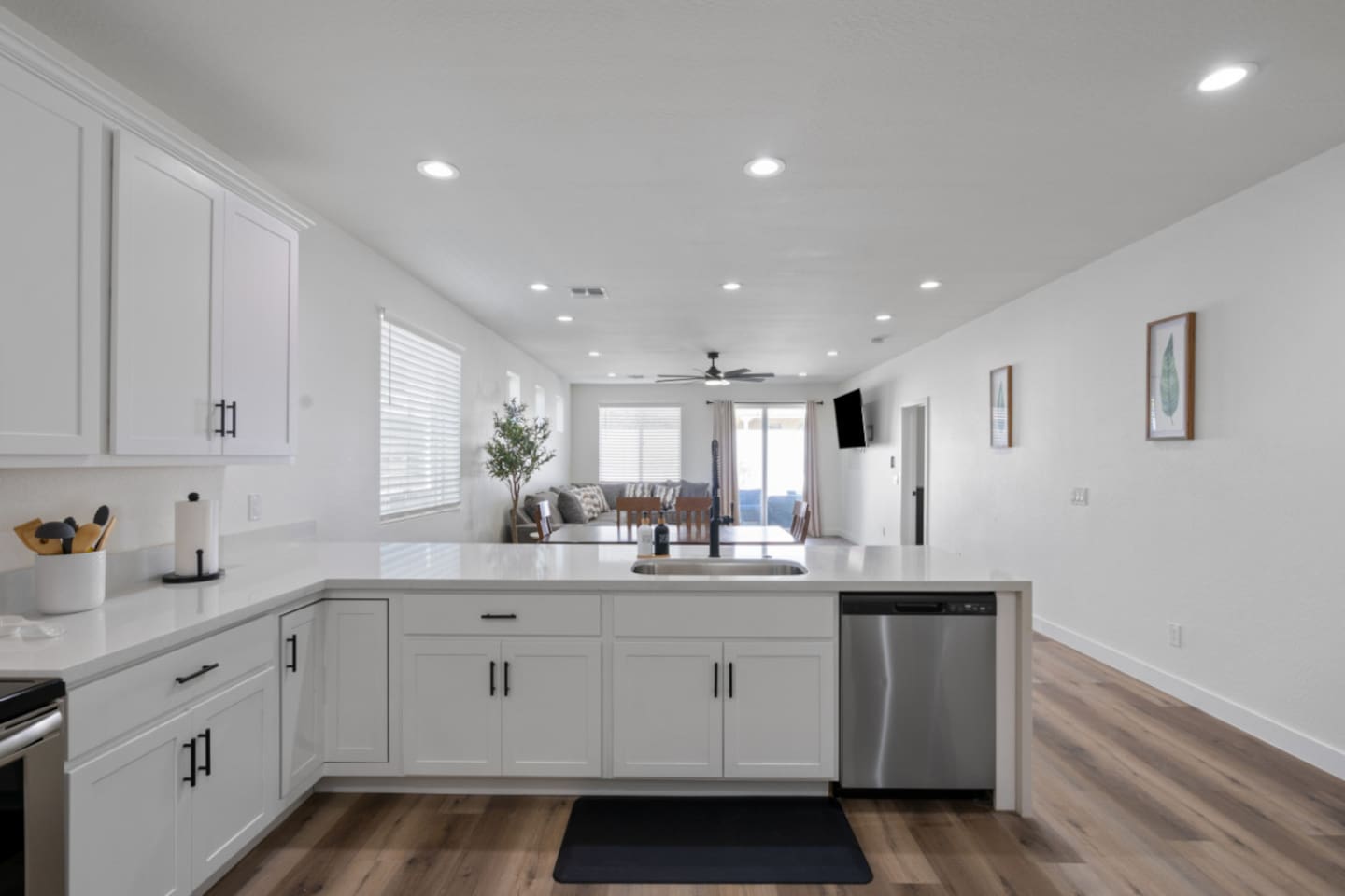 Full kitchen with stainless steel appliances, white cabinetry, dishwasher, and plenty of counter space for everyday meals.