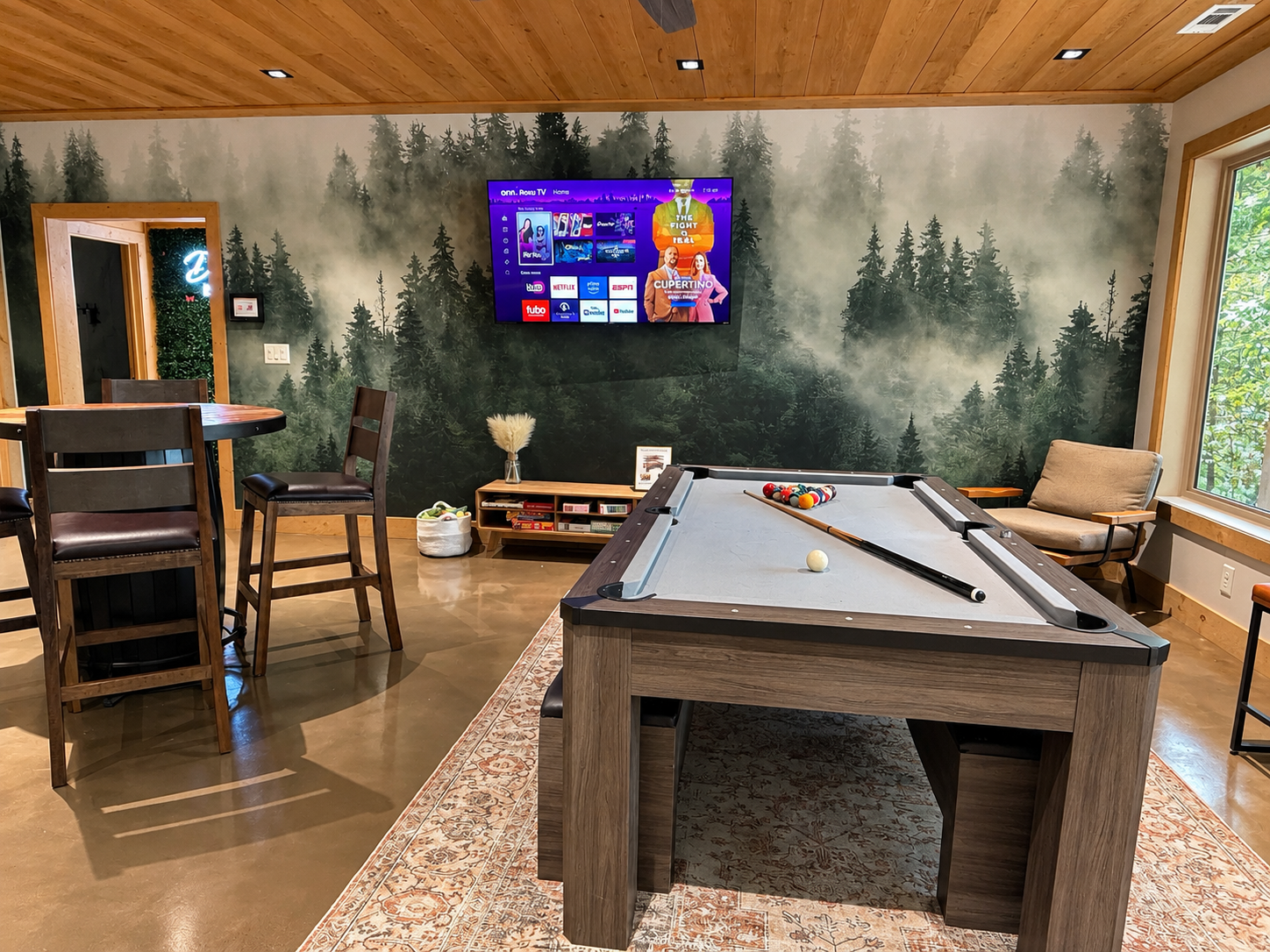 Game room with ping pong topper over pool table and pub table