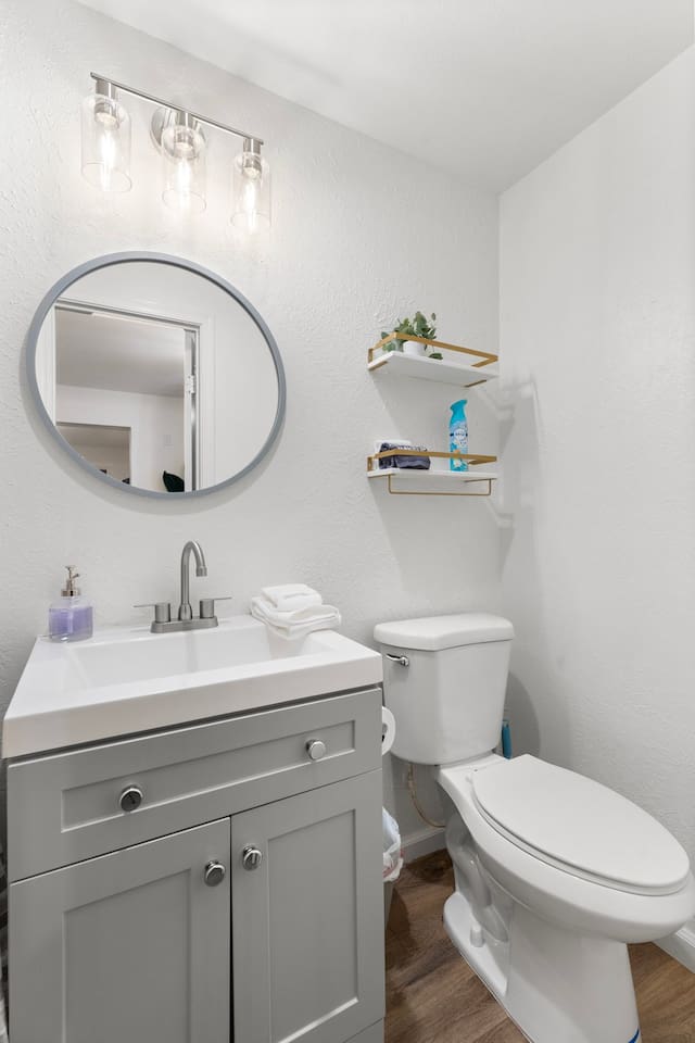 Modern vanity with round mirror and sleek lighting creates a bright, refreshing space.