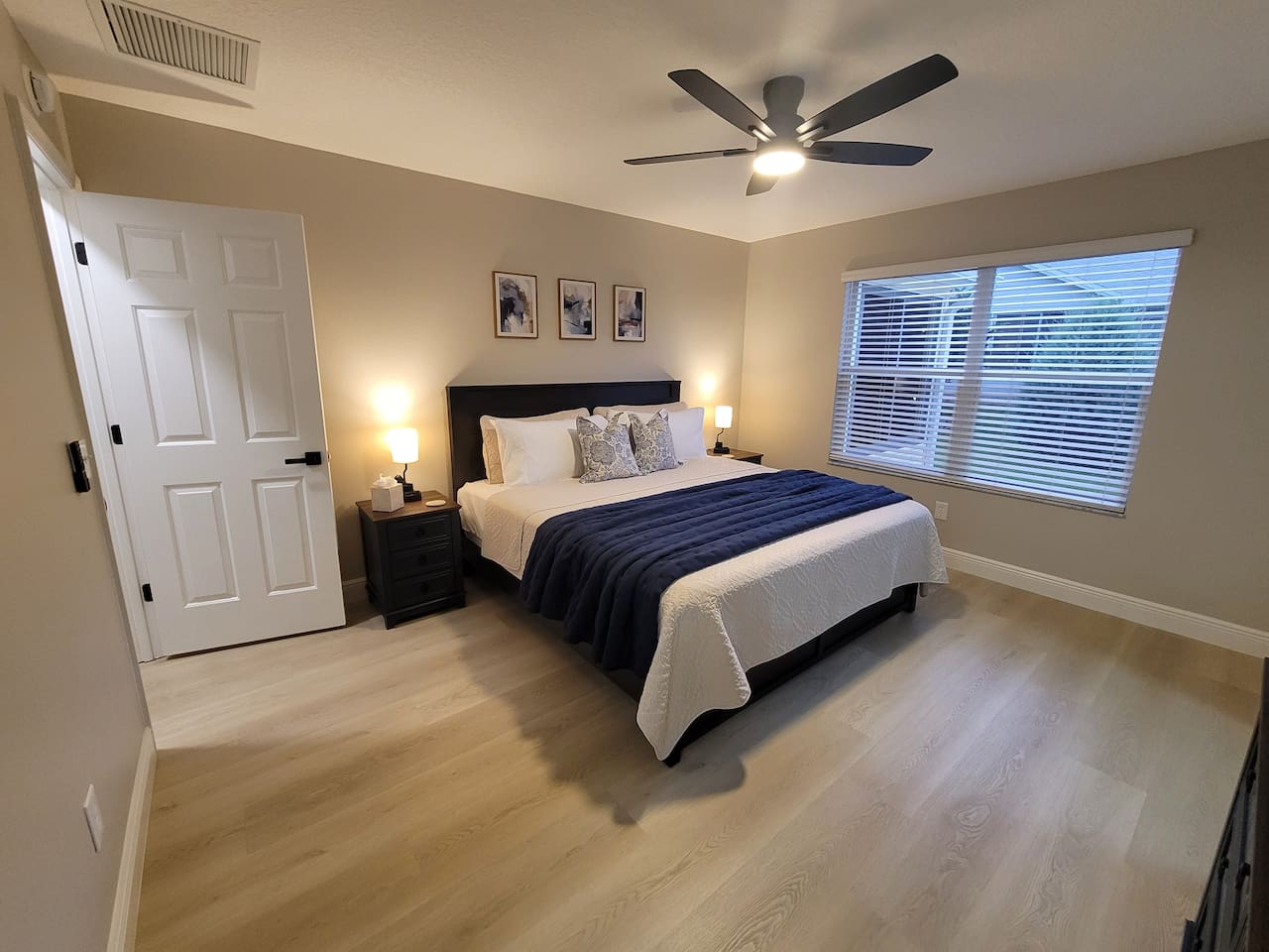 Retreat to the spacious primary king suite, featuring premium linens, bedside lighting, and a serene atmosphere designed for relaxation. The perfect place to unwind and recharge after a day of enjoying The Villages.