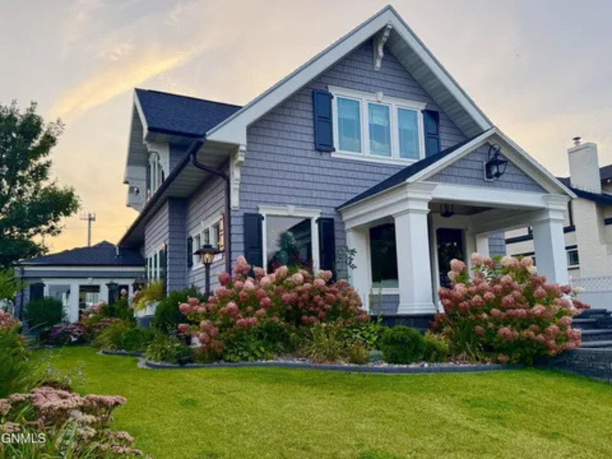 A charming front porch and blooming landscaping make this home feel welcoming from the moment you arrive.