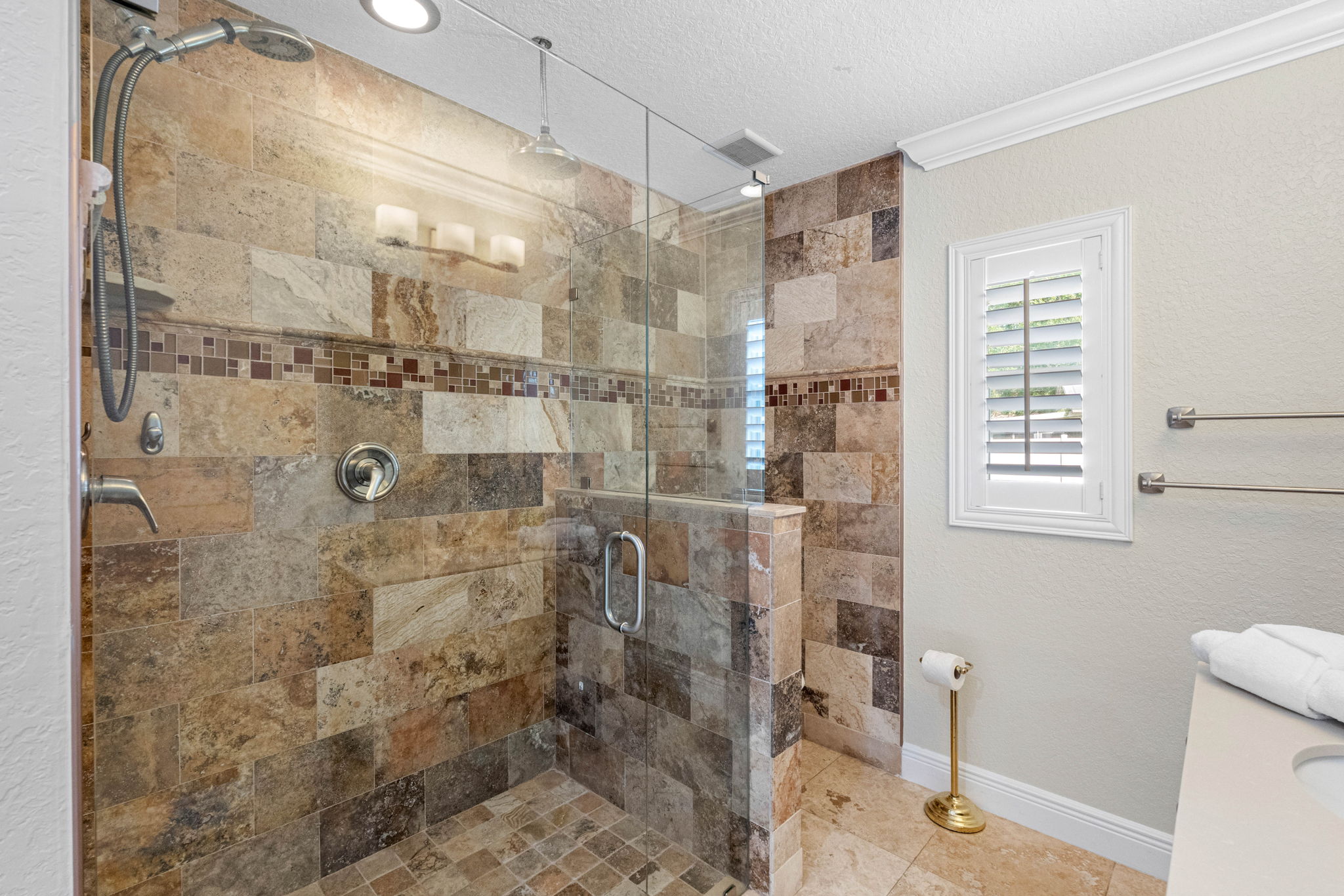 This stylish bathroom features an enclosed walk-in shower with modern tilework and excellent water pressure.