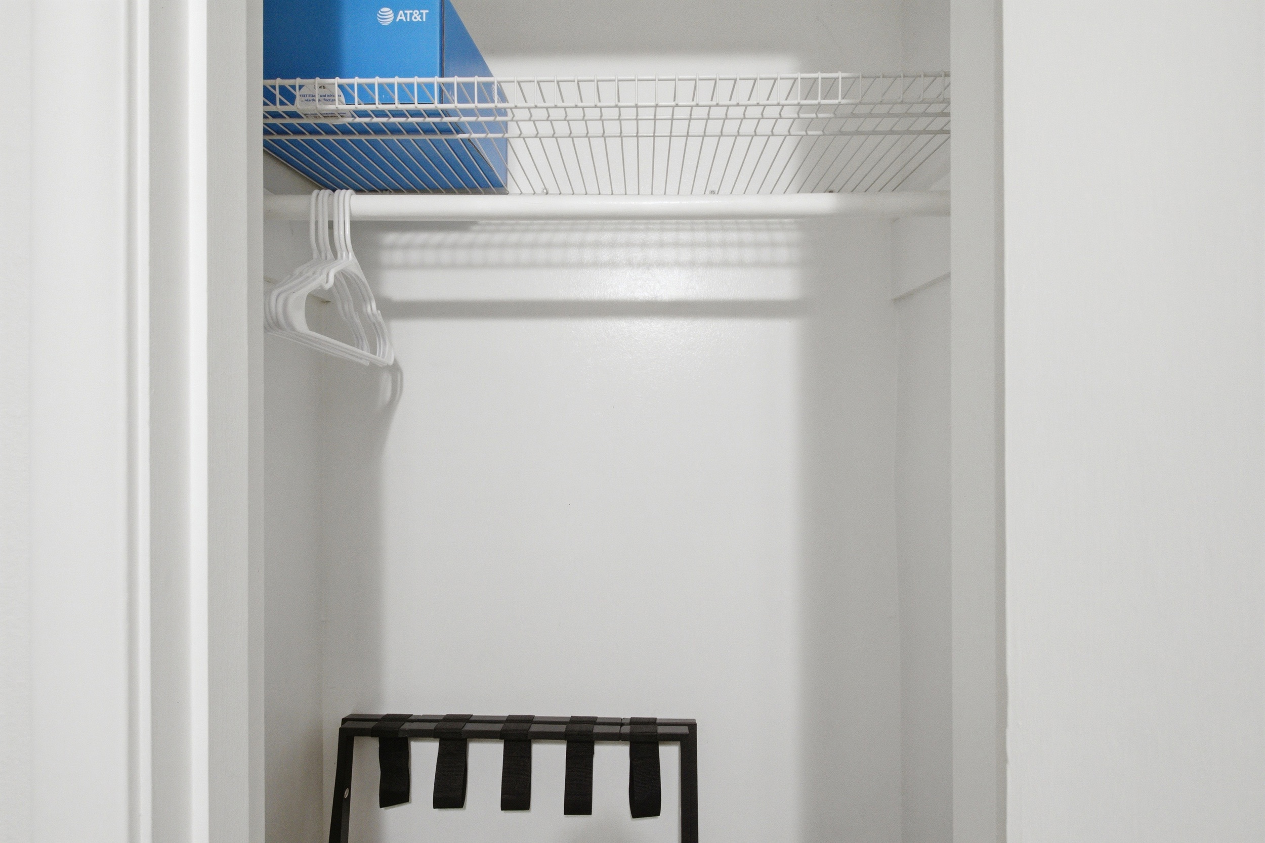 Bedroom 3 Closet with Hangers and a Luggage Rack ready for unpacking. Perfect for extended stays during Cowboys, Rangers, or concert weekends.


