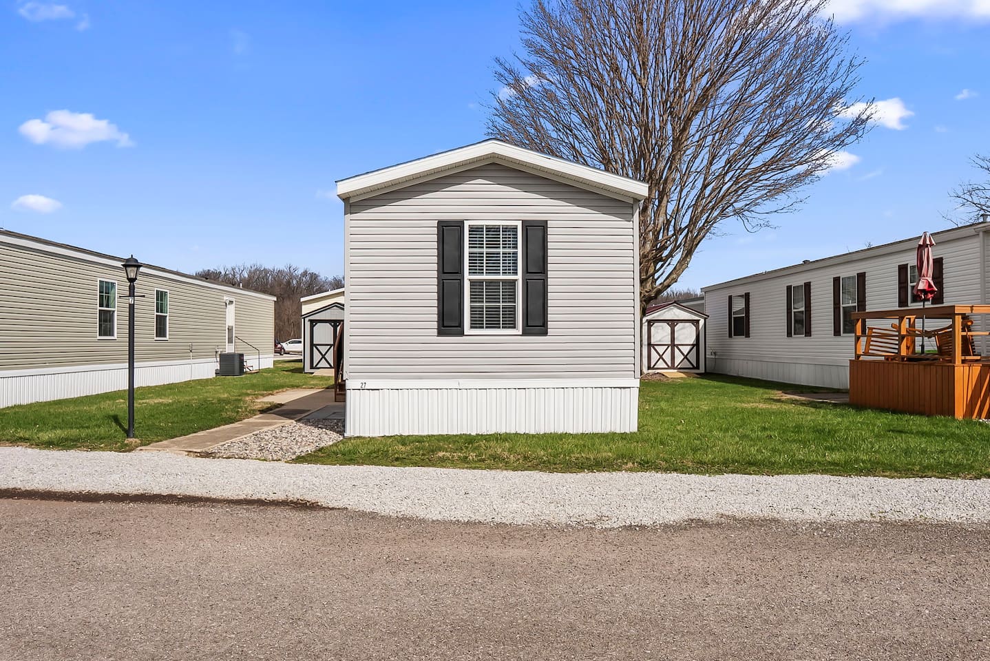Front-facing view of the home with open surroundings and convenient parking nearby.