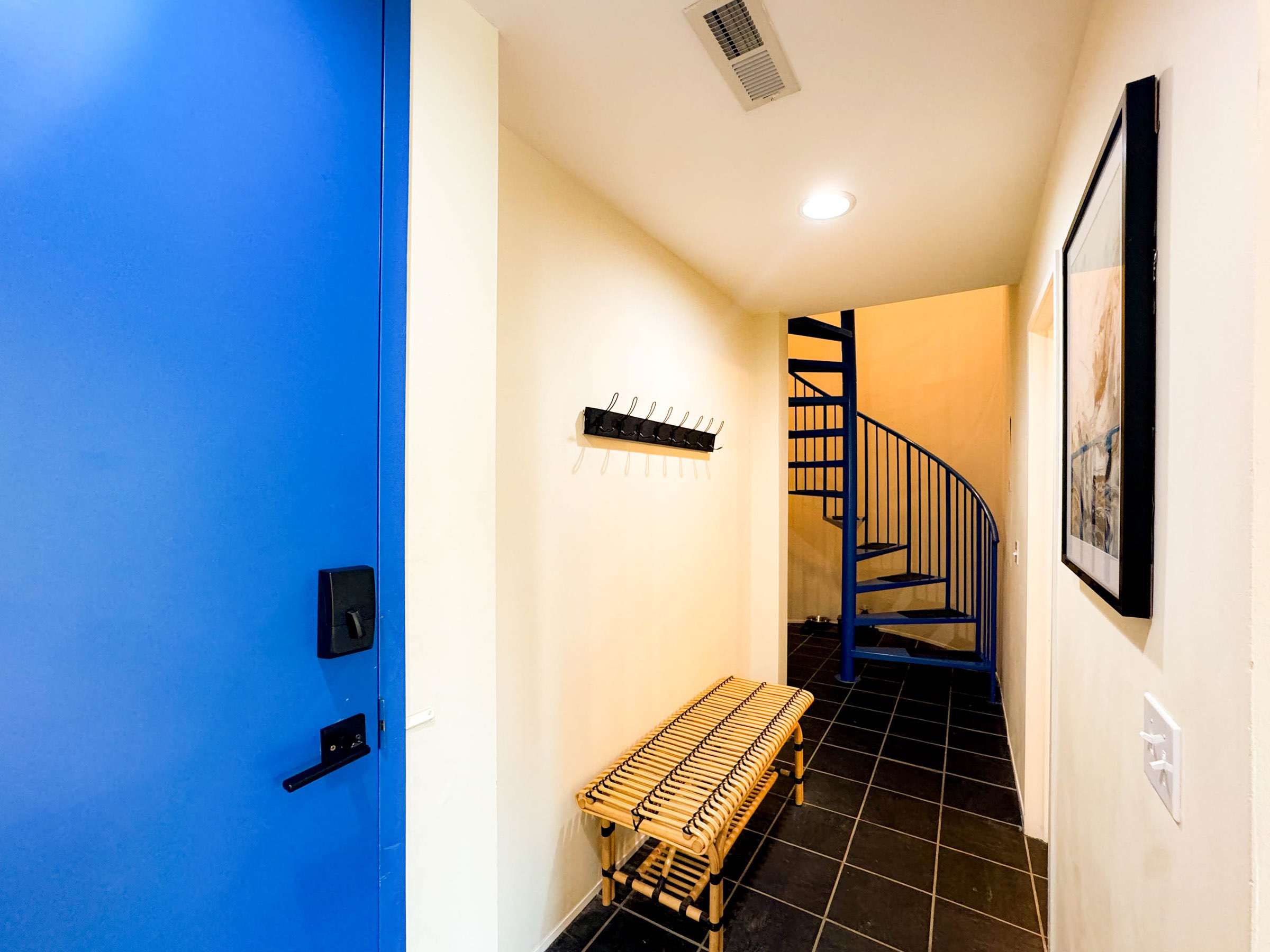 Electronic door code for easy self check-in. The extra tall door is a nice feature of the home as well! The spiral staircase will take you to the two upstairs bedrooms.