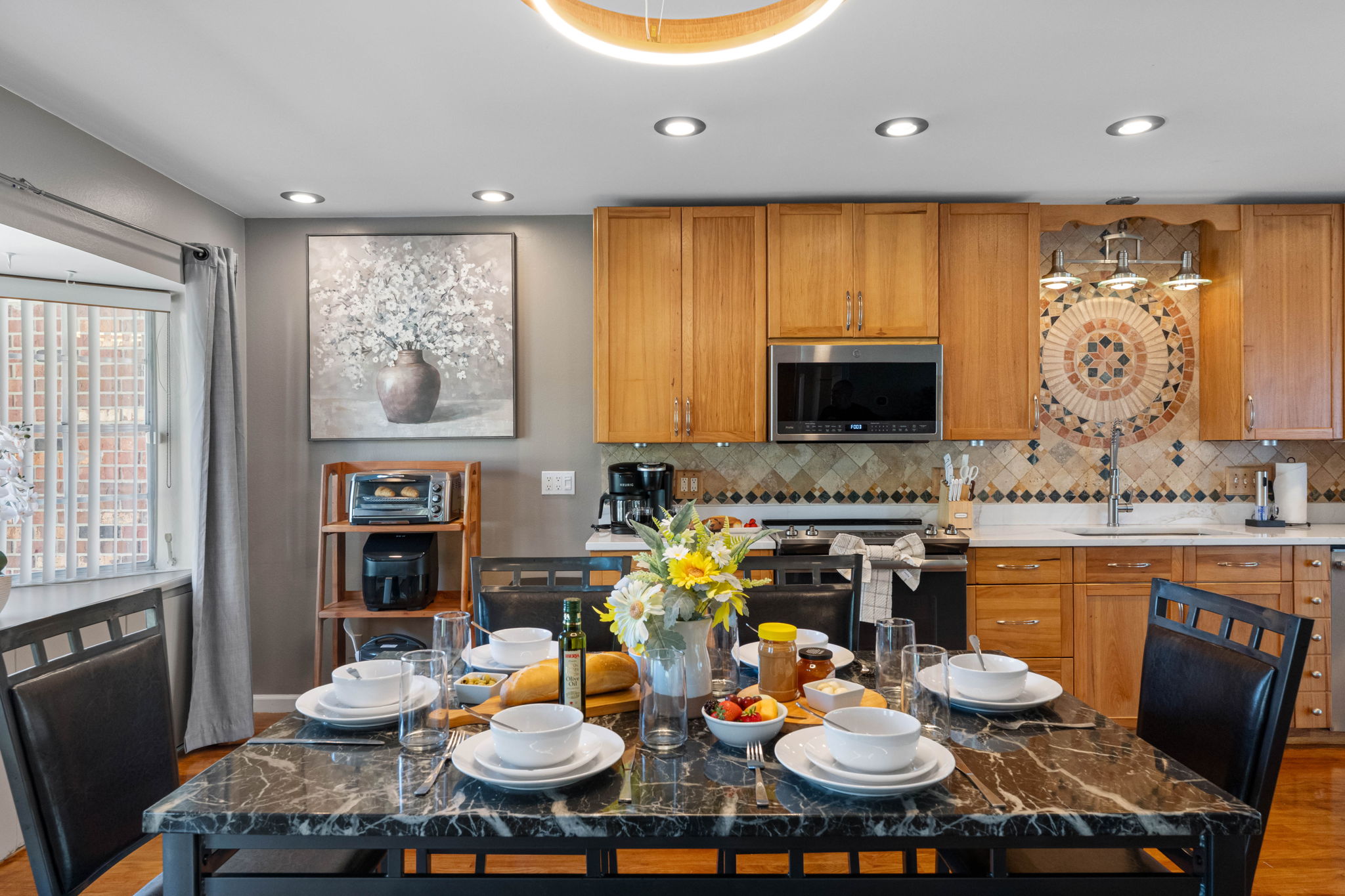 Natural wood cabinetry meets modern stainless steel appliances, creating a perfect balance between rustic charm and modern style.