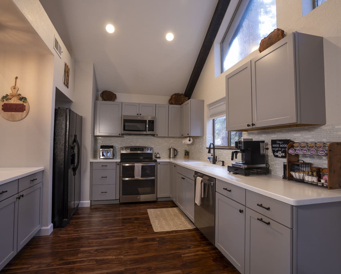 Bright kitchen with high ceilings, full-size appliances, and space for simple meals during your stay.