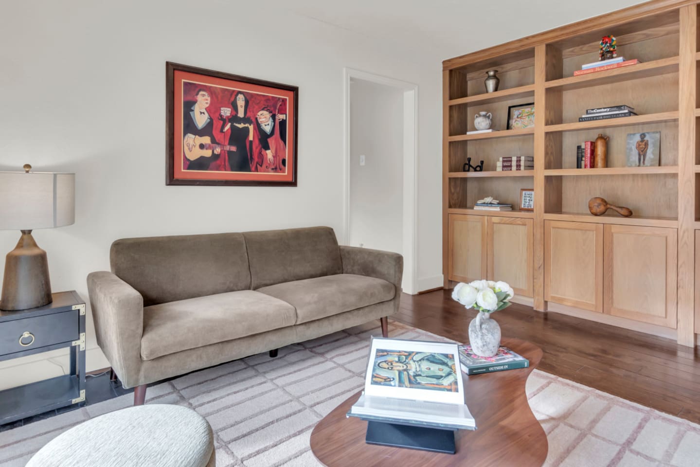 Comfortable sitting area featuring a plush sofa and curated artwork, creating a warm and stylish space to relax, read, or unwind during your stay.