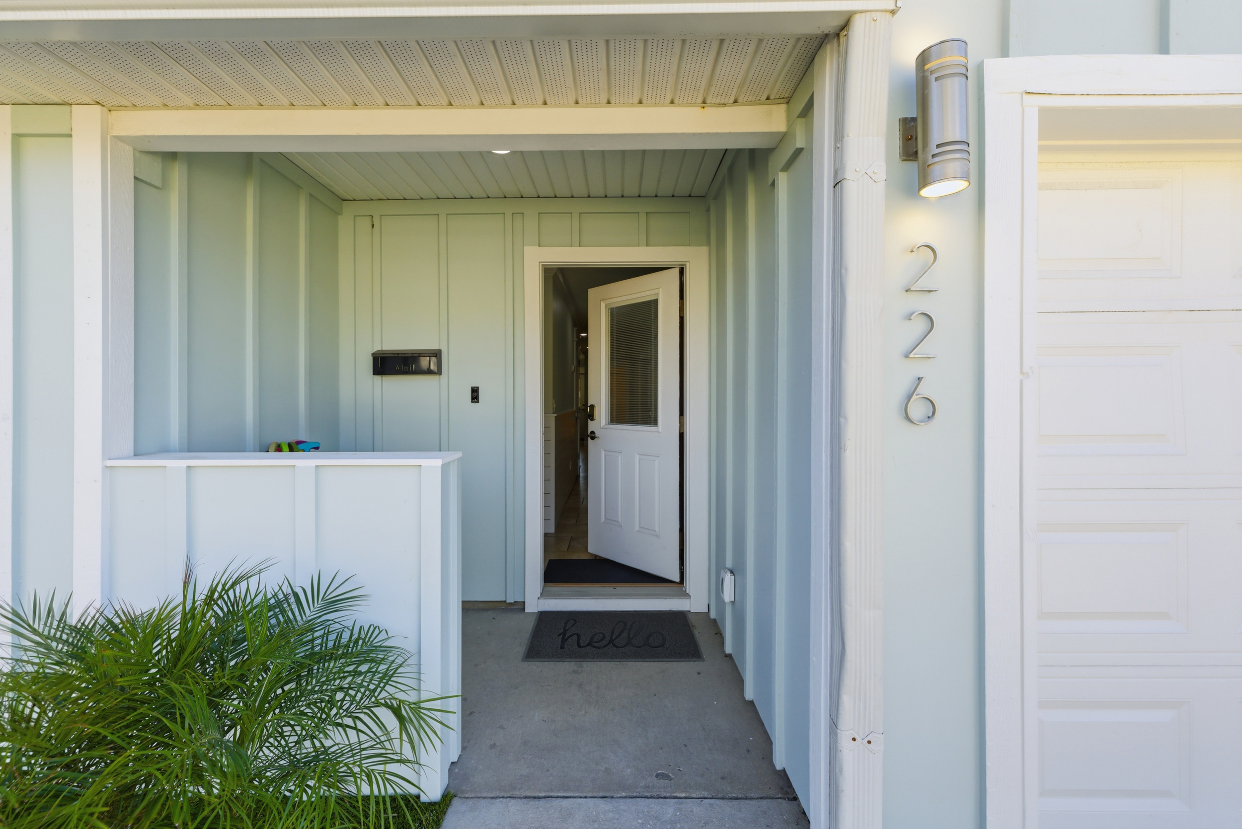 Front door and entryway with house number visible