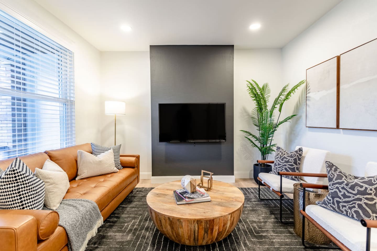 Spacious living area with modern furniture, offering a comfortable and stylish space to relax.