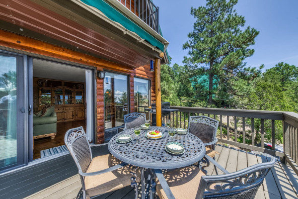 The cabin patio offers the best of nature — stunning views and an outside grill, perfect for unwinding and cooking in a peaceful setting