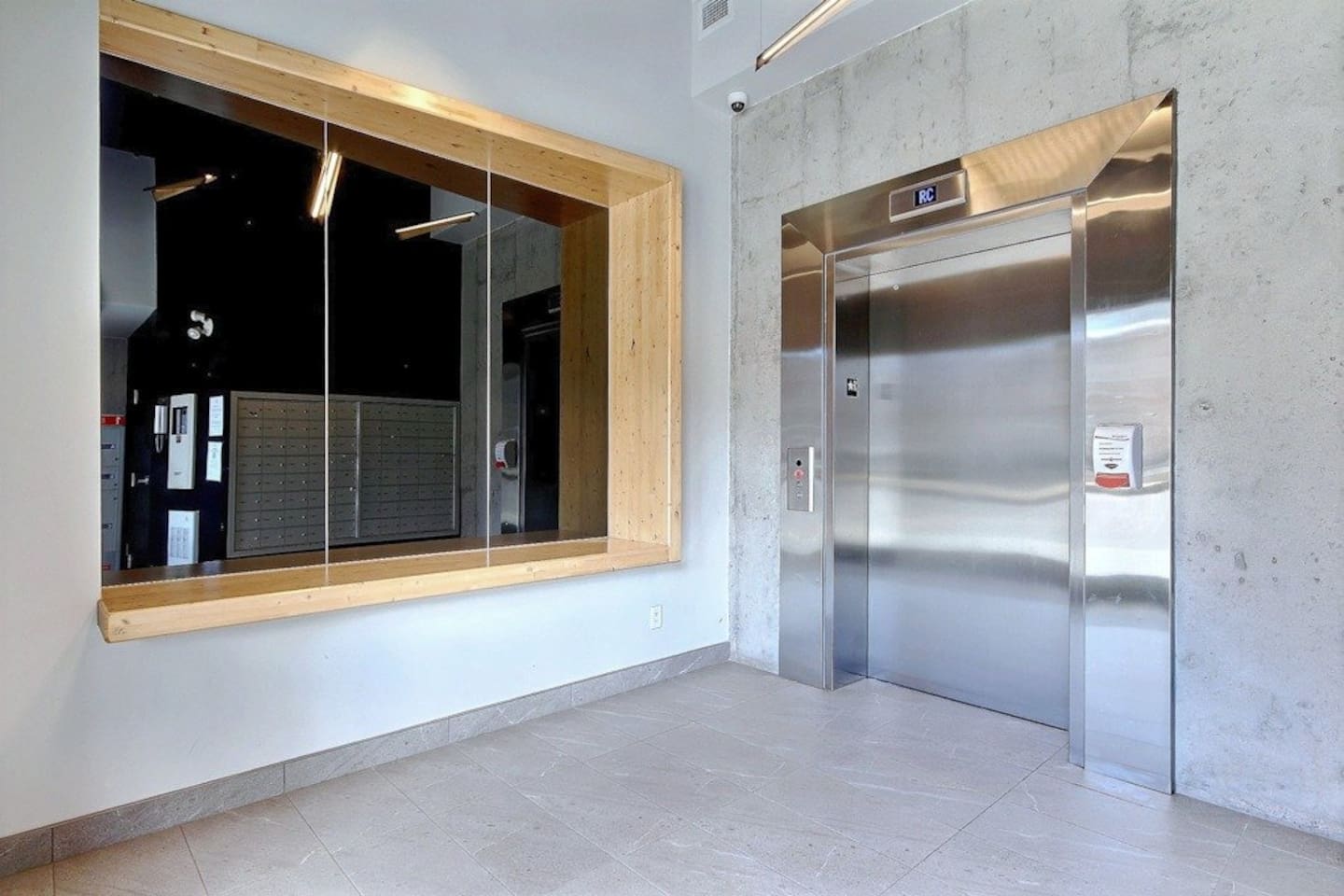 Entrée du bâtiment avec ascenseurs. Il est possible de se rendre au logement sans emprunter les escaliers.