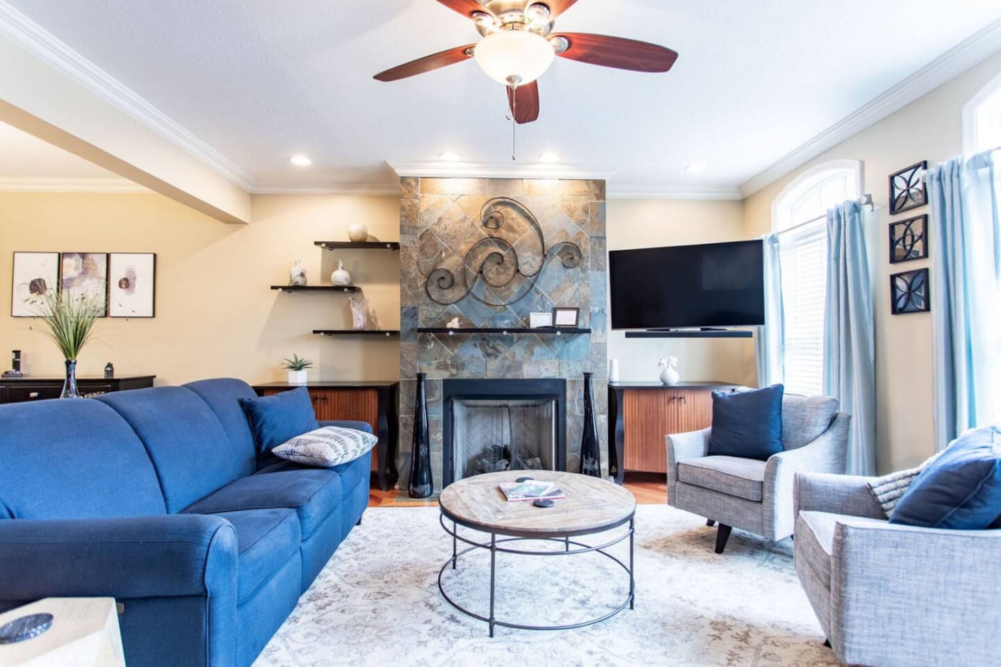 Living room with blue accent décor, complemented by stylish, comfortable furniture that creates a vibrant yet relaxing atmosphere.