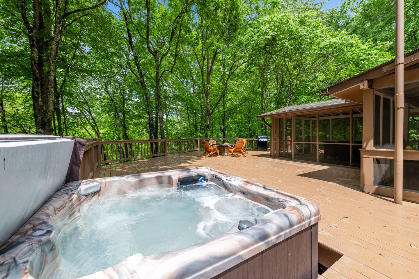 The back deck on the cabin has a hot tub and gas fire pit along with a gas grill.  It is a great space for the group to gather and do different activites. It also has the screened in porch on one side for additonal spaces for people to eat and play games.