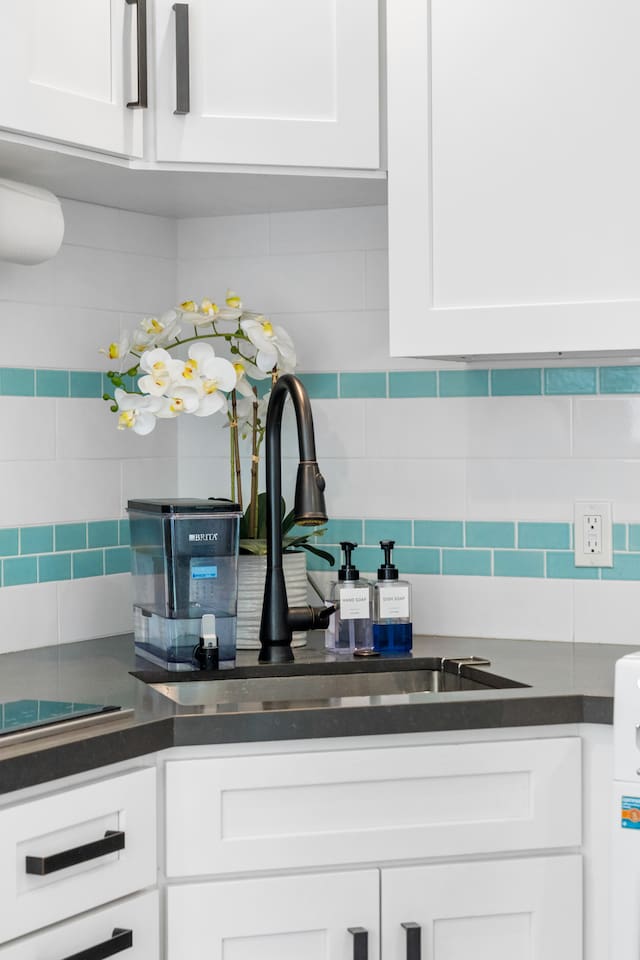 This kitchen corner has a clean, modern look with a crisp white-and-black color scheme, creating an inviting space for daily use. Simple yet stylish!