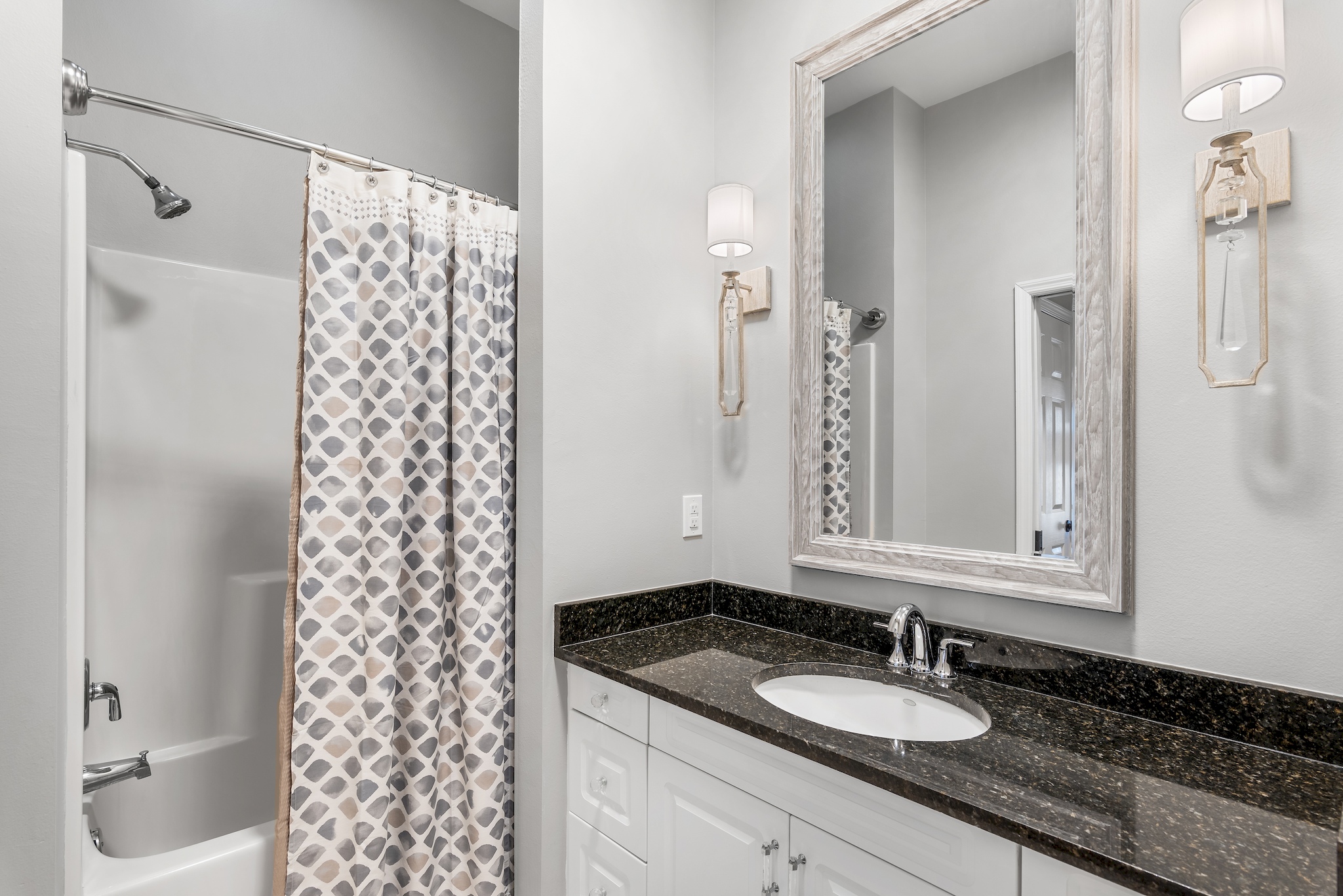 Ensuite bathroom with granite vanity and shower/tub combination