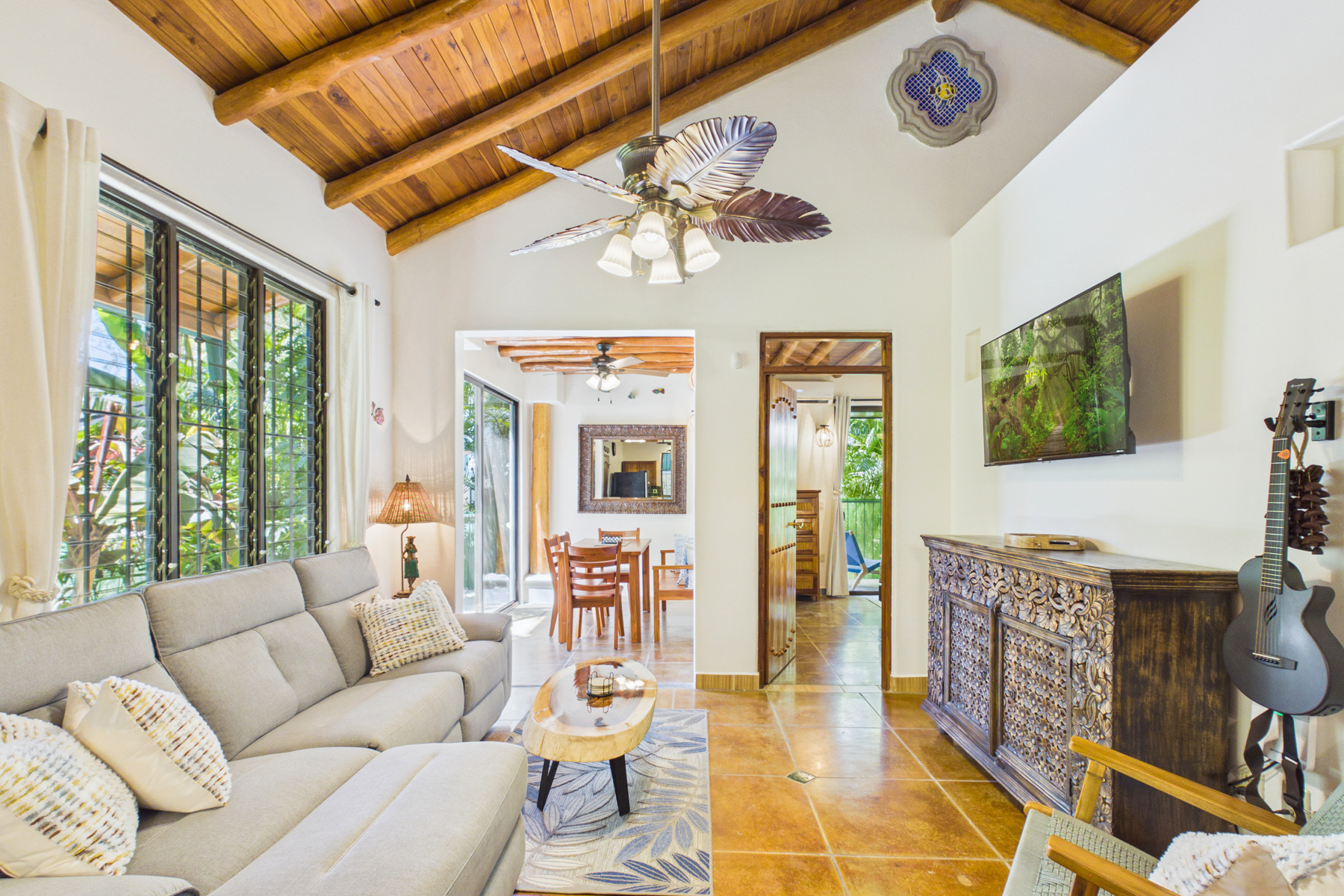 Living room open to indoor dining room.  Smart TV in Den.  Guitar for guests to use.