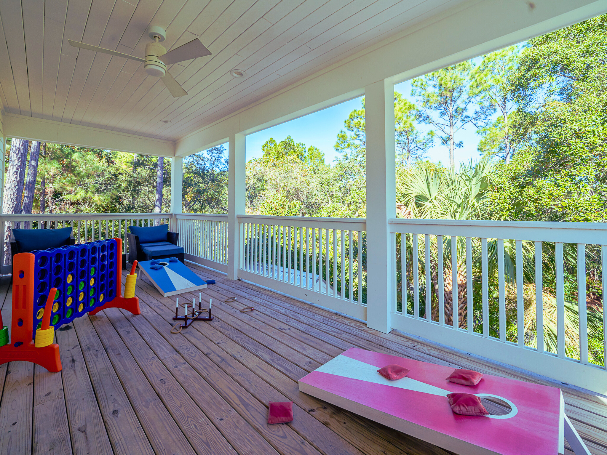Spacious deck with seating areas, cornhole, and ring toss - perfect for outdoor fun and relaxing evenings
