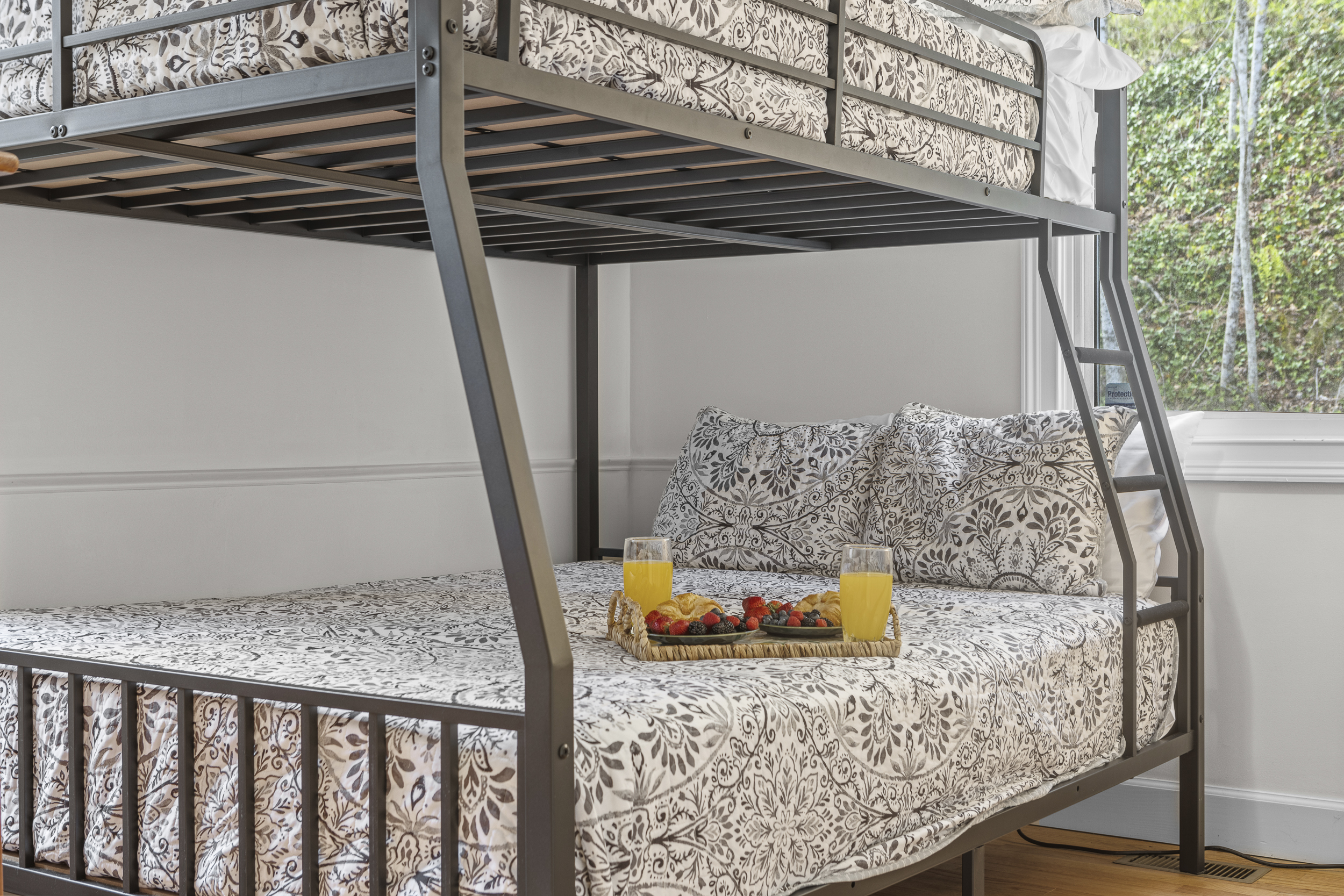 Bunk Room 1: Enjoy fun-filled nights with friends on stylish bunks and a tasty breakfast spread!