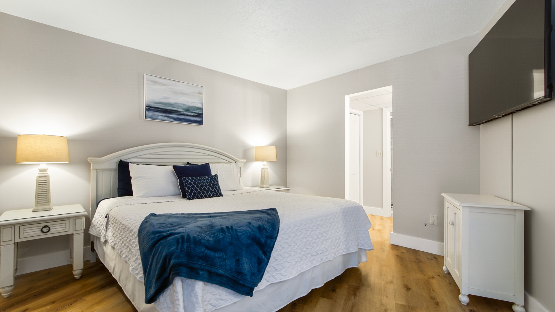 Main bedroom with king bed, ensuite bathroom, smart TV and clothing storage