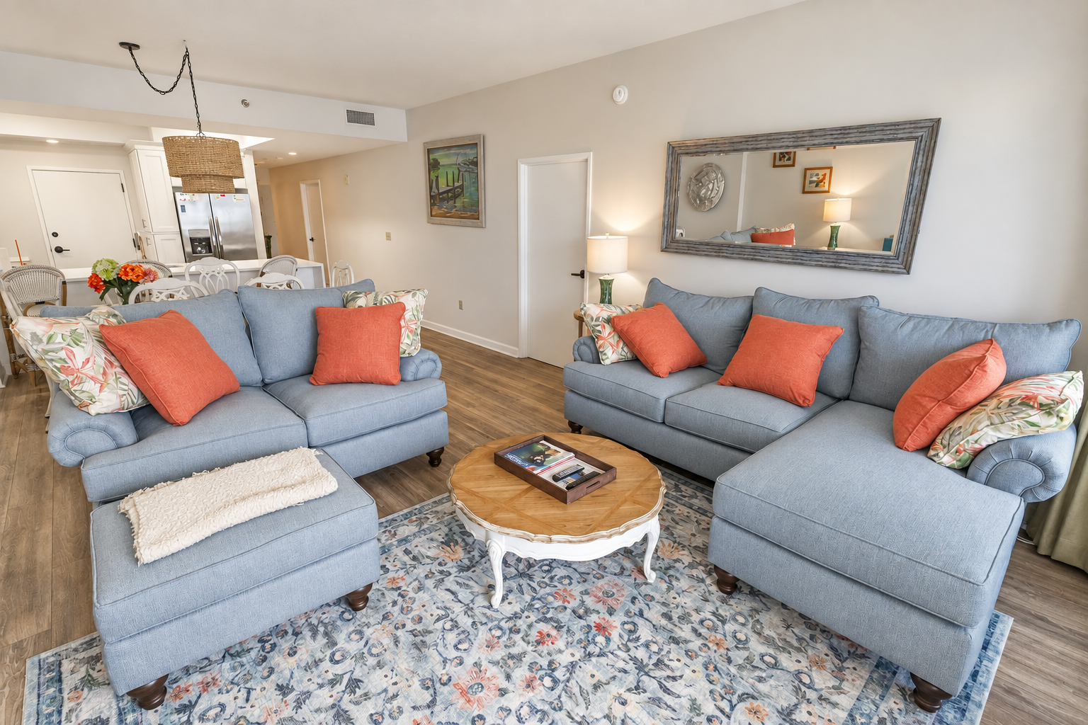 Updated living-room seating with an open dining area and kitchen beyond.