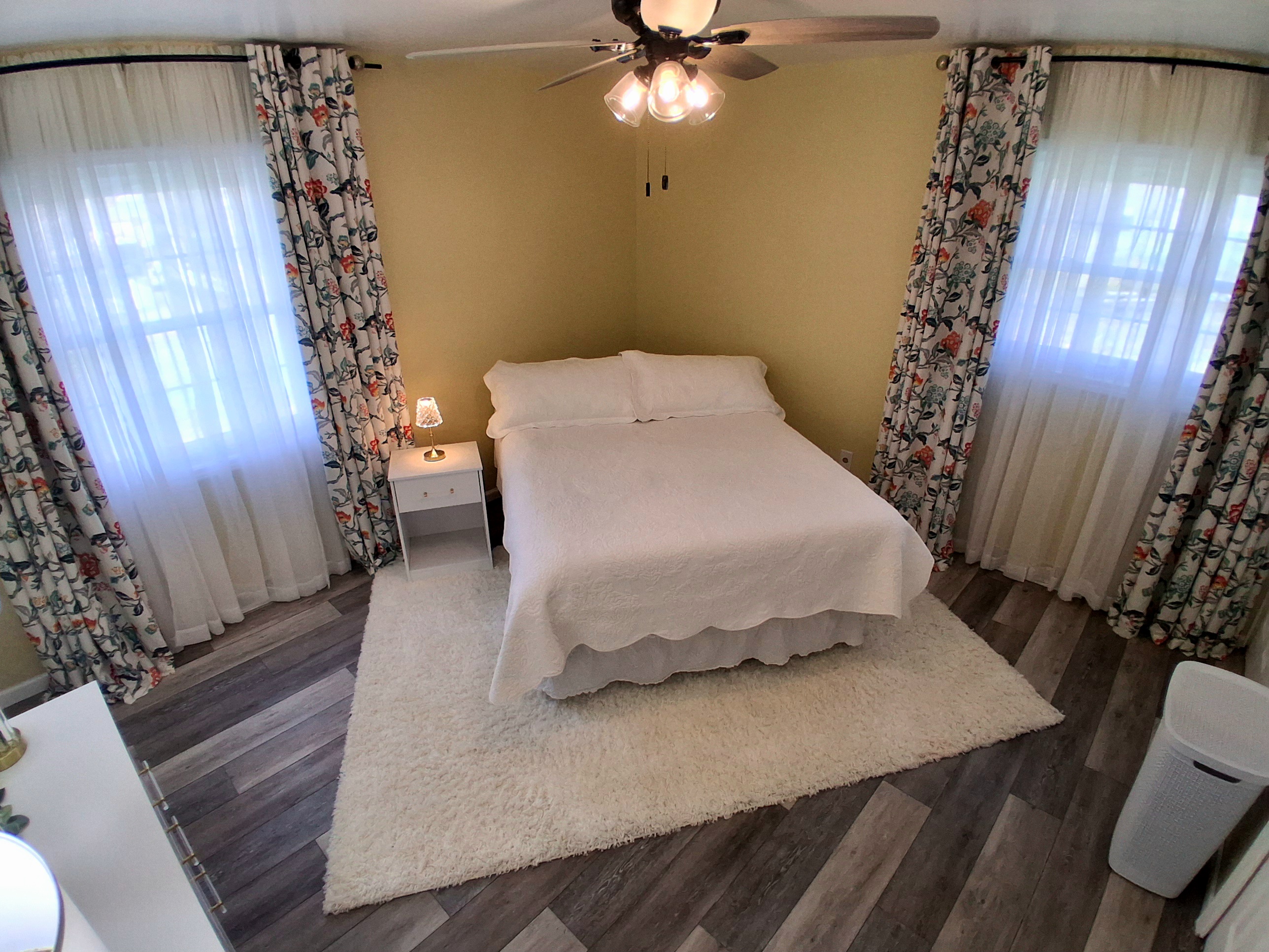 This room has a queen bed with a comfy 12" cooling foam mattress & a dresser. Guests love the peaceful half-acre backyard view. And yes—there’s a sleek black urinal in the private bathroom, a playful nod to comfort and style.