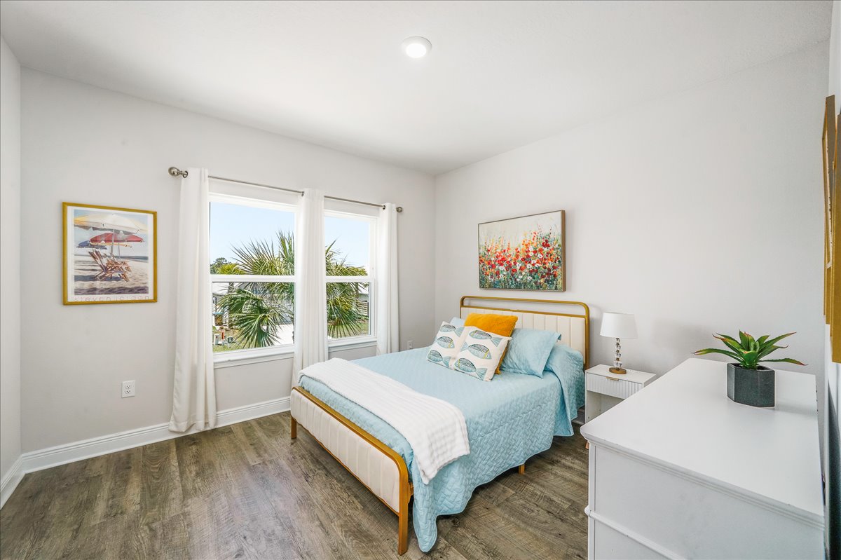 Bedroom 3: Queen Bed with soft coastal linens, closet, luggage stand, and nightstand for a relaxing stay.
