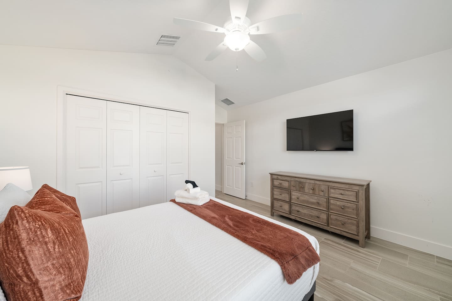 Guest bedroom with smart TV and storage