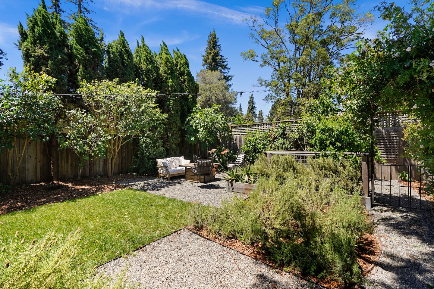 Private backyard retreat featuring a hot tub, fire pit, and multiple outdoor seating areas perfect for relaxing nights.