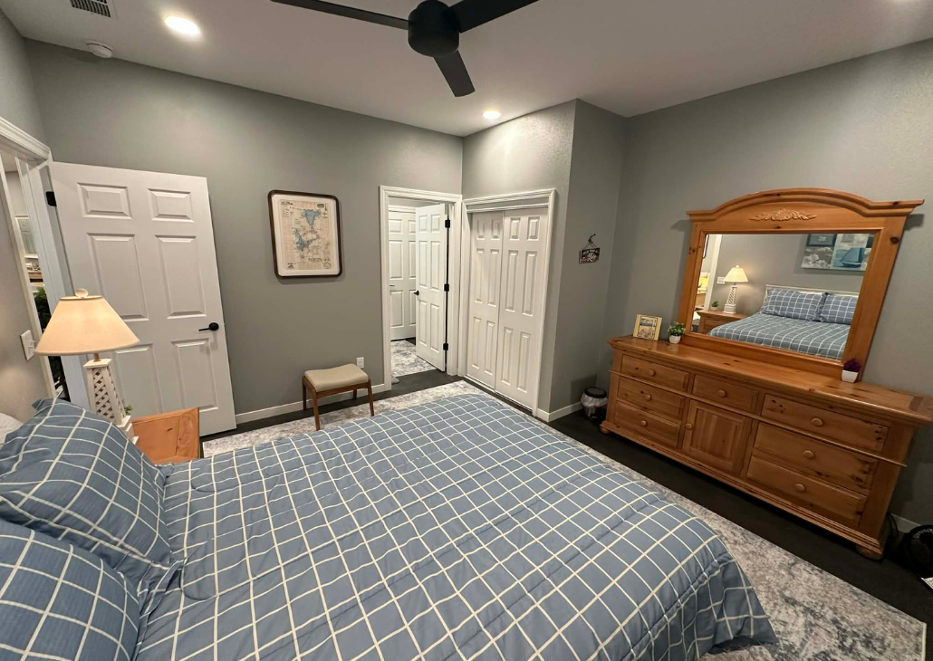 Bedroom 1 with ceiling fan and queen bed.