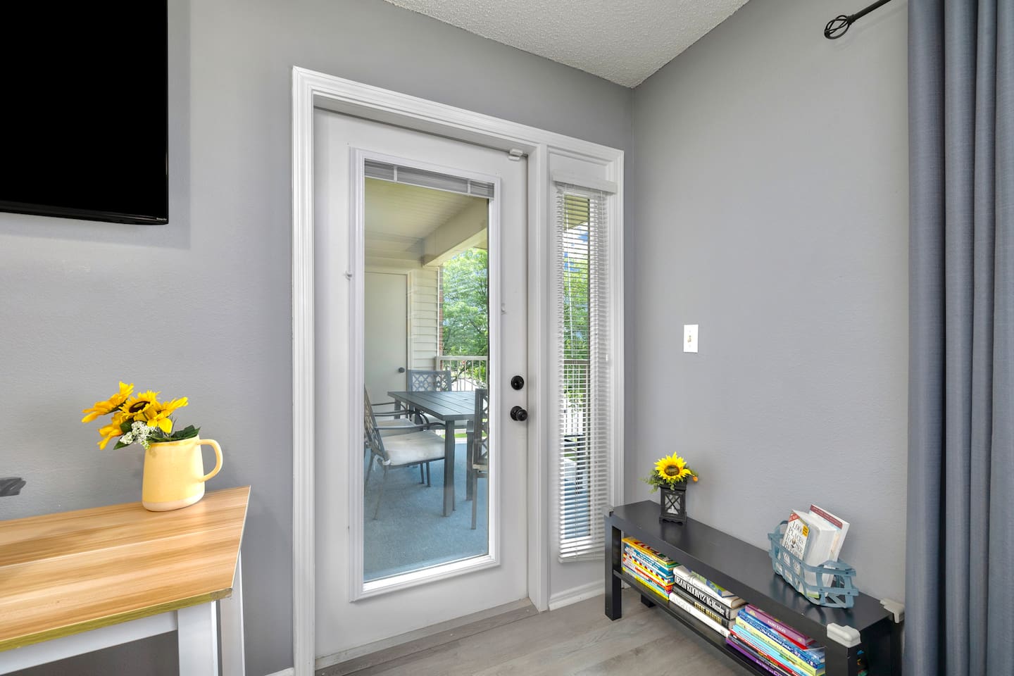 Sunlit Retreat: Step through the doors to a charming patio, perfect for brunch and relaxation!