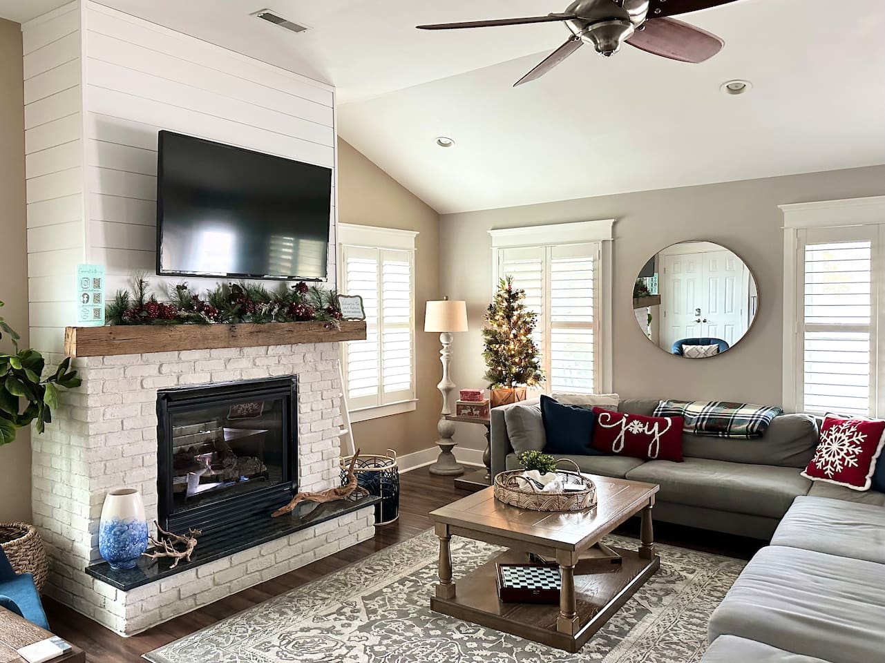 Decorated in November, the home features a cozy fireplace, festive snowflake pillows on the sofa, and a sparkling Christmas tree, creating the perfect atmosphere for a relaxing seasonal stay.