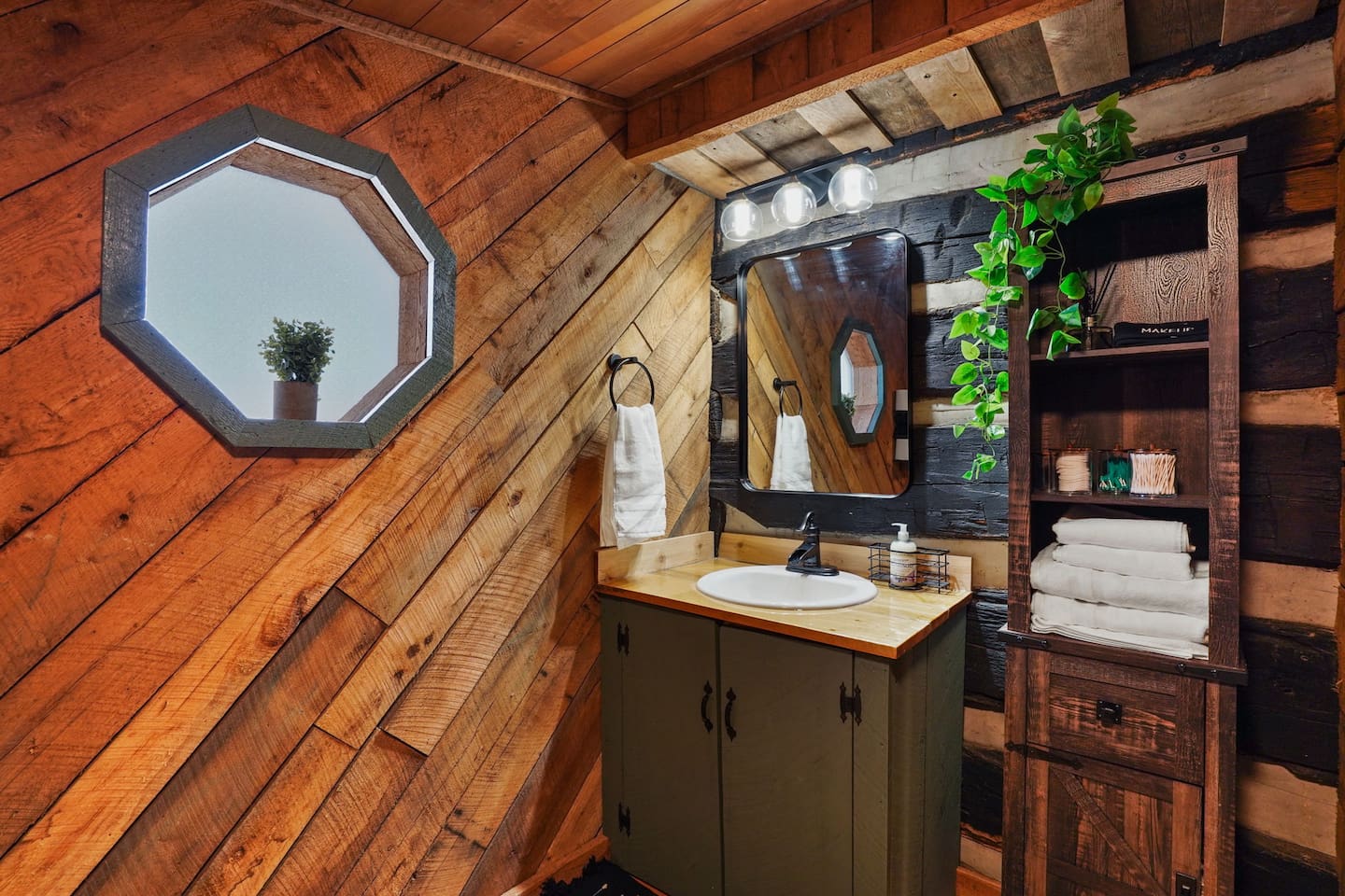 Bathroom featuring a waterfall sink, toiletries, and bath towels.