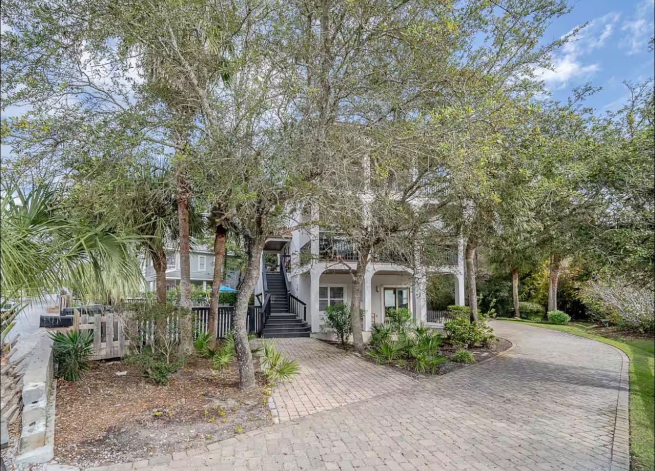 Welcoming exterior view showcasing private parking and the scenic entryway to your 30A vacation home