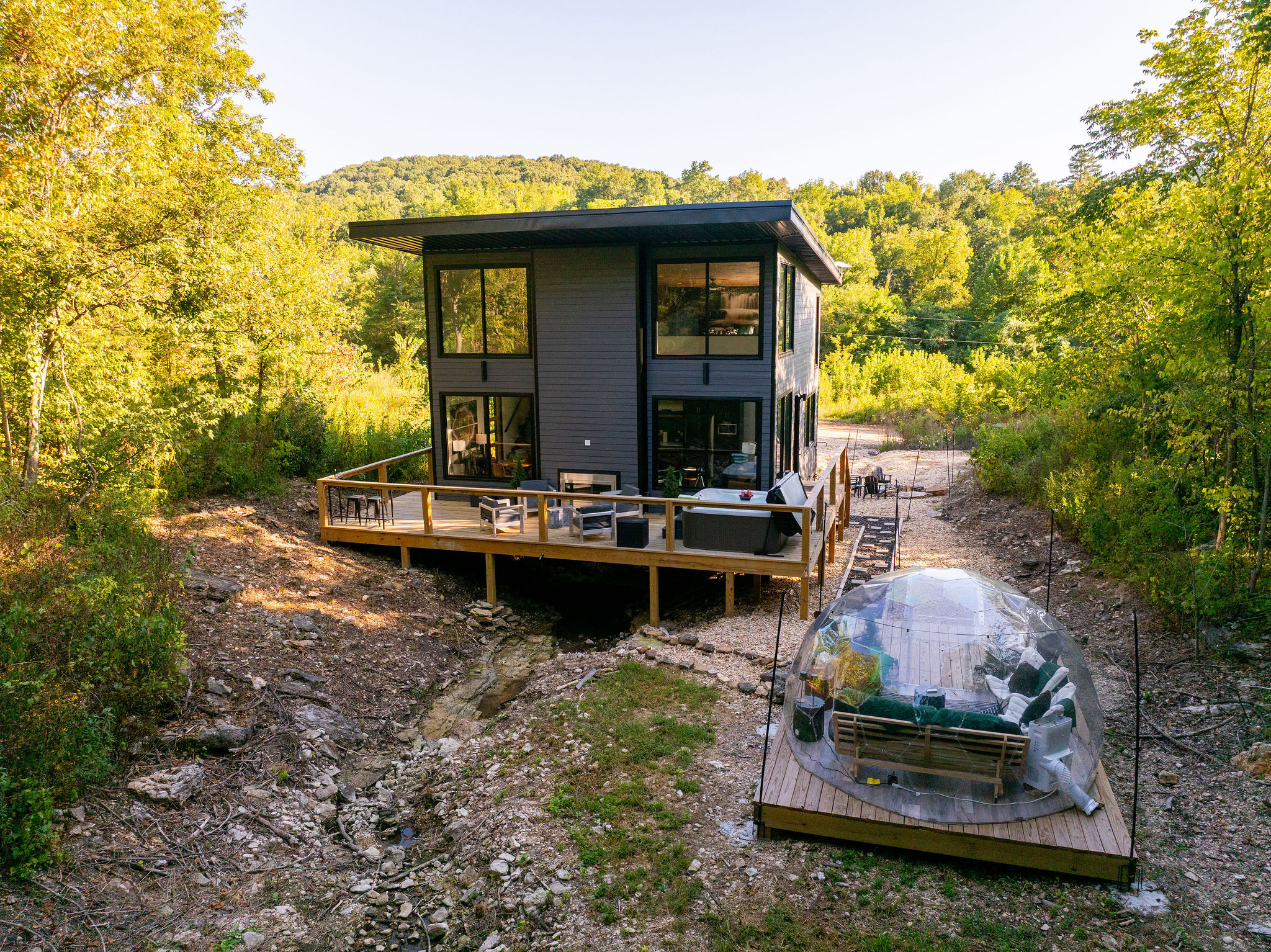 Modern glass architecture tucked into the Ozark woods near Table Rock Lake.