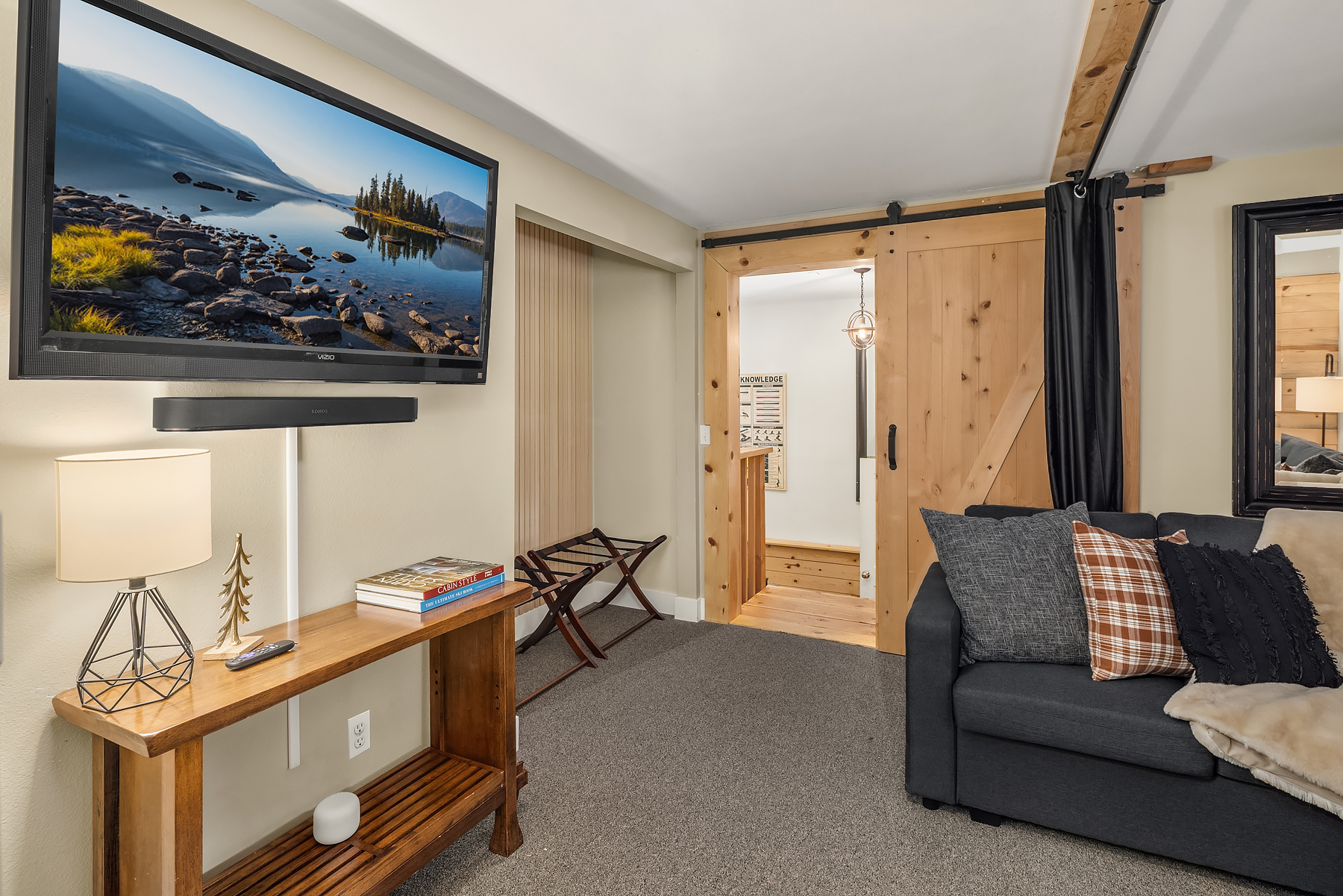 Lower level TV room with full-sized pull-out couch, and curtains to provide additional privacy