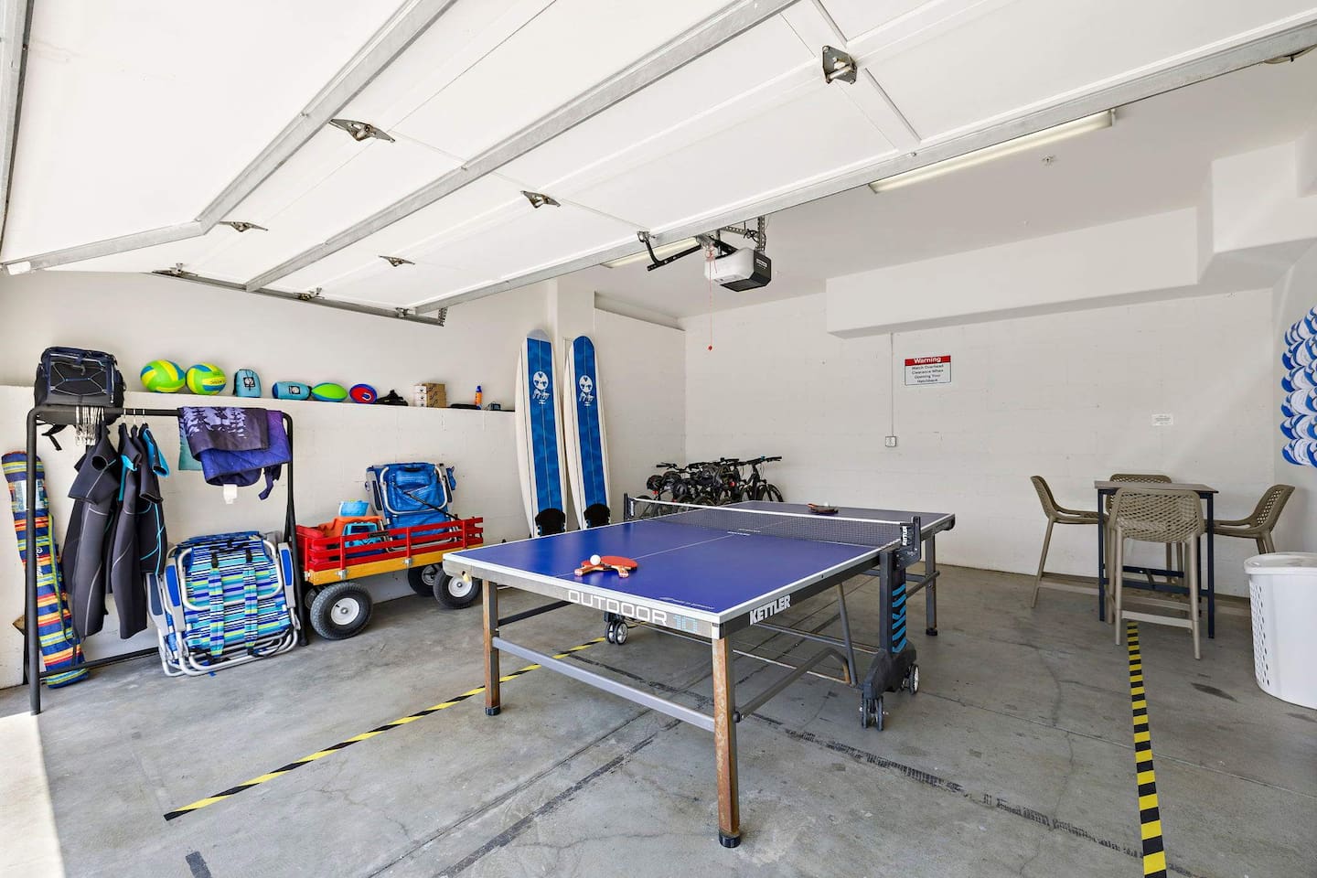 Garage with ping pong table unfolded.  It folds easily to clear the area for parking.
